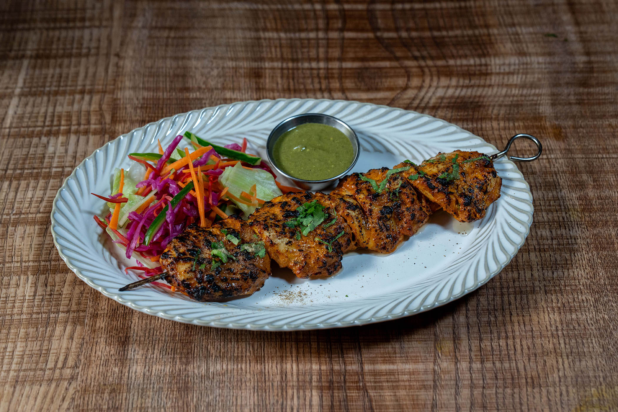 ‘Gnarly, warmly spiced extremities… moist in the middle’: chicken tikka with mint chutney
