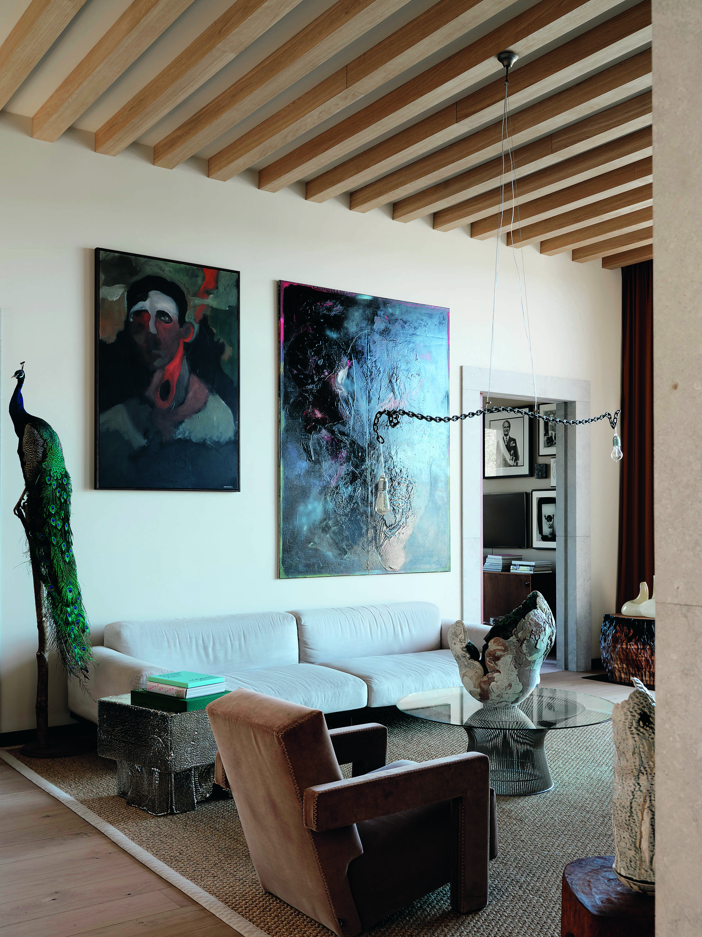 Light work: a lamp and chain sculpture in the living room hangs above a glass table and a sculpture by Sylvain Rieu-Piquet