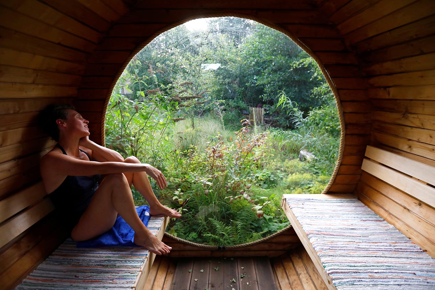 Sauna with a circular window at a rental property near Glasgow