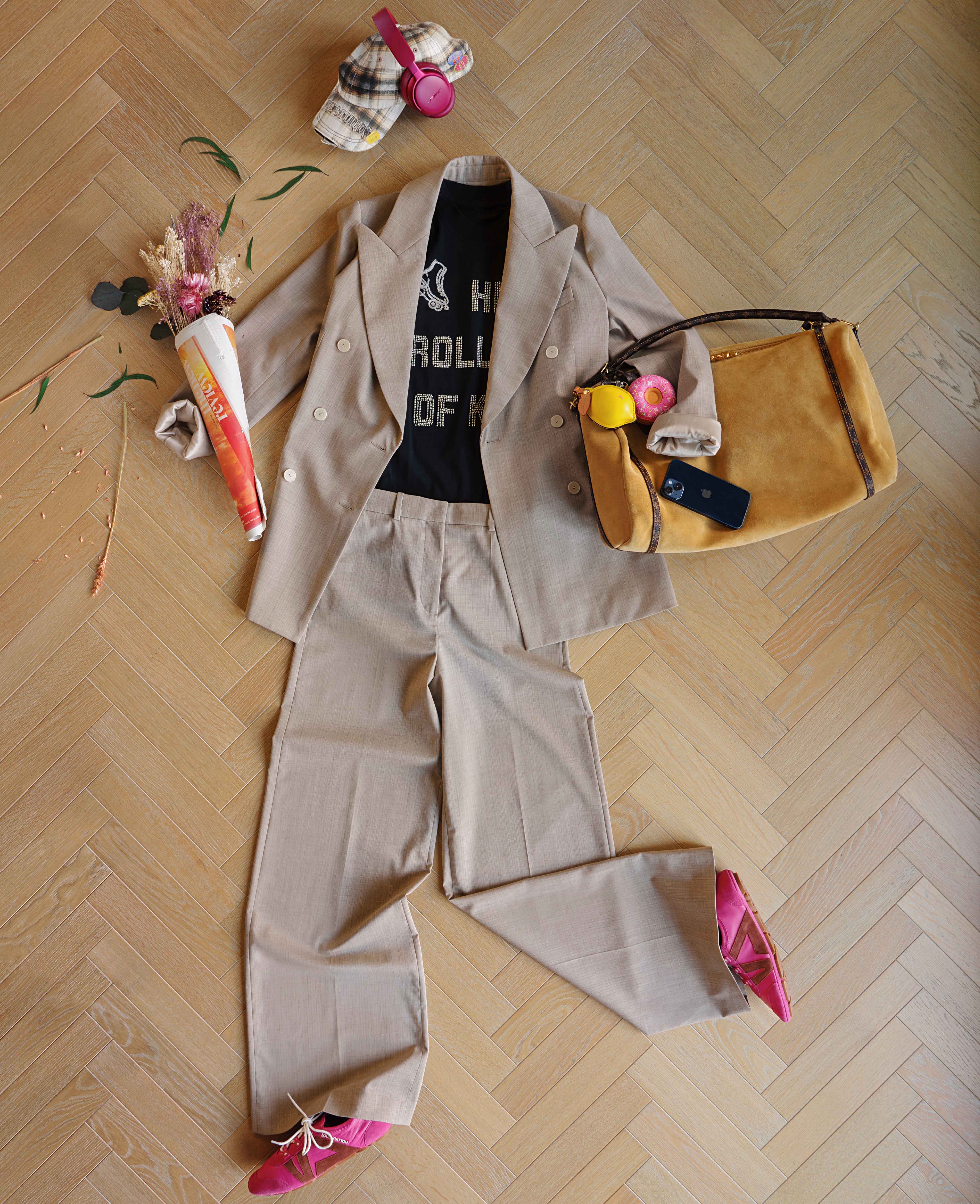 Cap £230, Acne Studios. QuietComfort headphones £449.95, BOSE. Blazer £695 and trousers £445, both JOSEPH. T-shirt £155, S.S. DALEY. Express MM bag £3,400, donut and lemon charms £710 each, pink sneakerina £735, all Louis Vuitton
