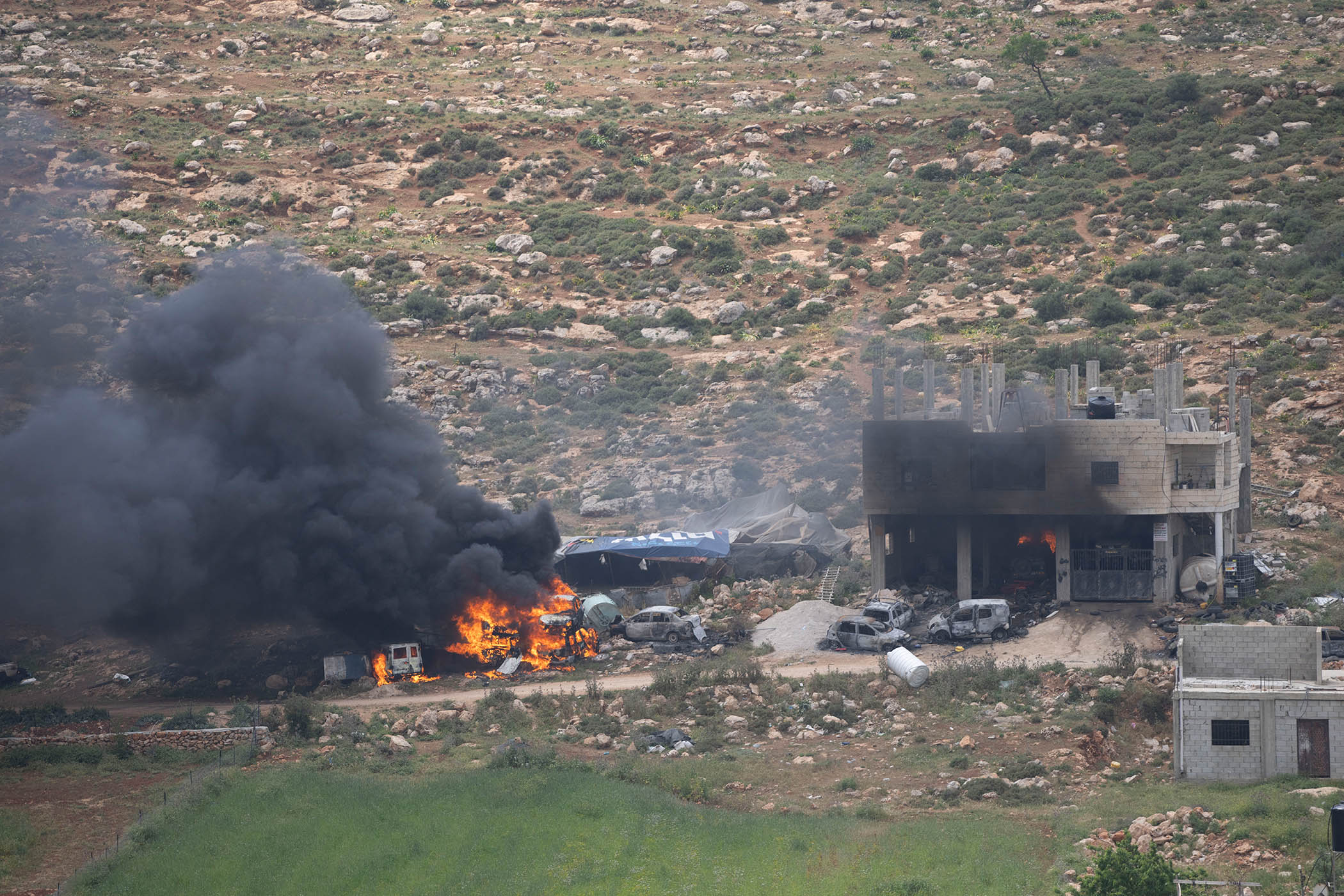 Palestinian properties are set on fire by Israeli settlers in al-Mughayyir in April 2023