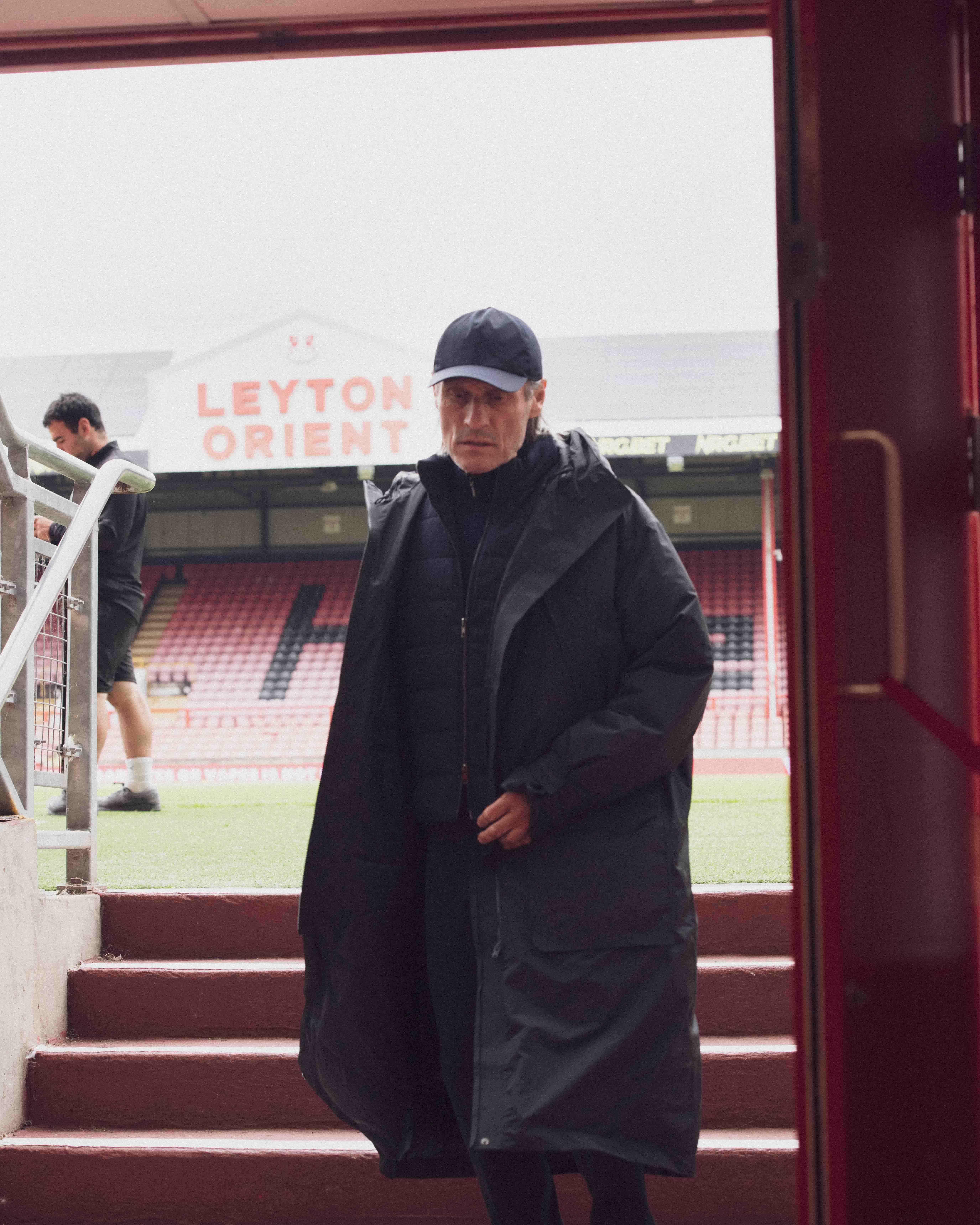 Coat by Y3 from Adidas; cap and trousers both by Hackett; and gilet and jumper both by Moss