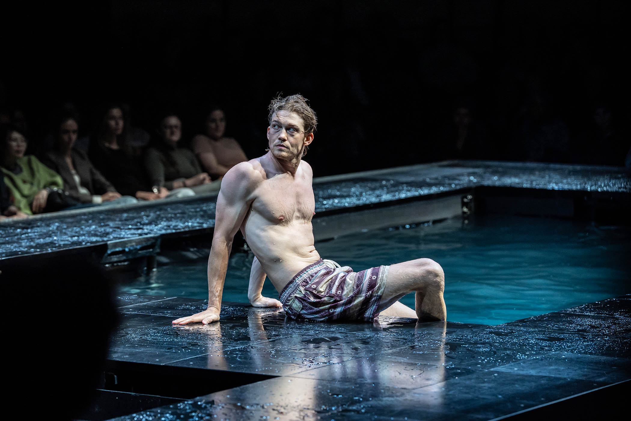 Joe Alwyn sits poolside during The Lady from the Sea at the Bridge