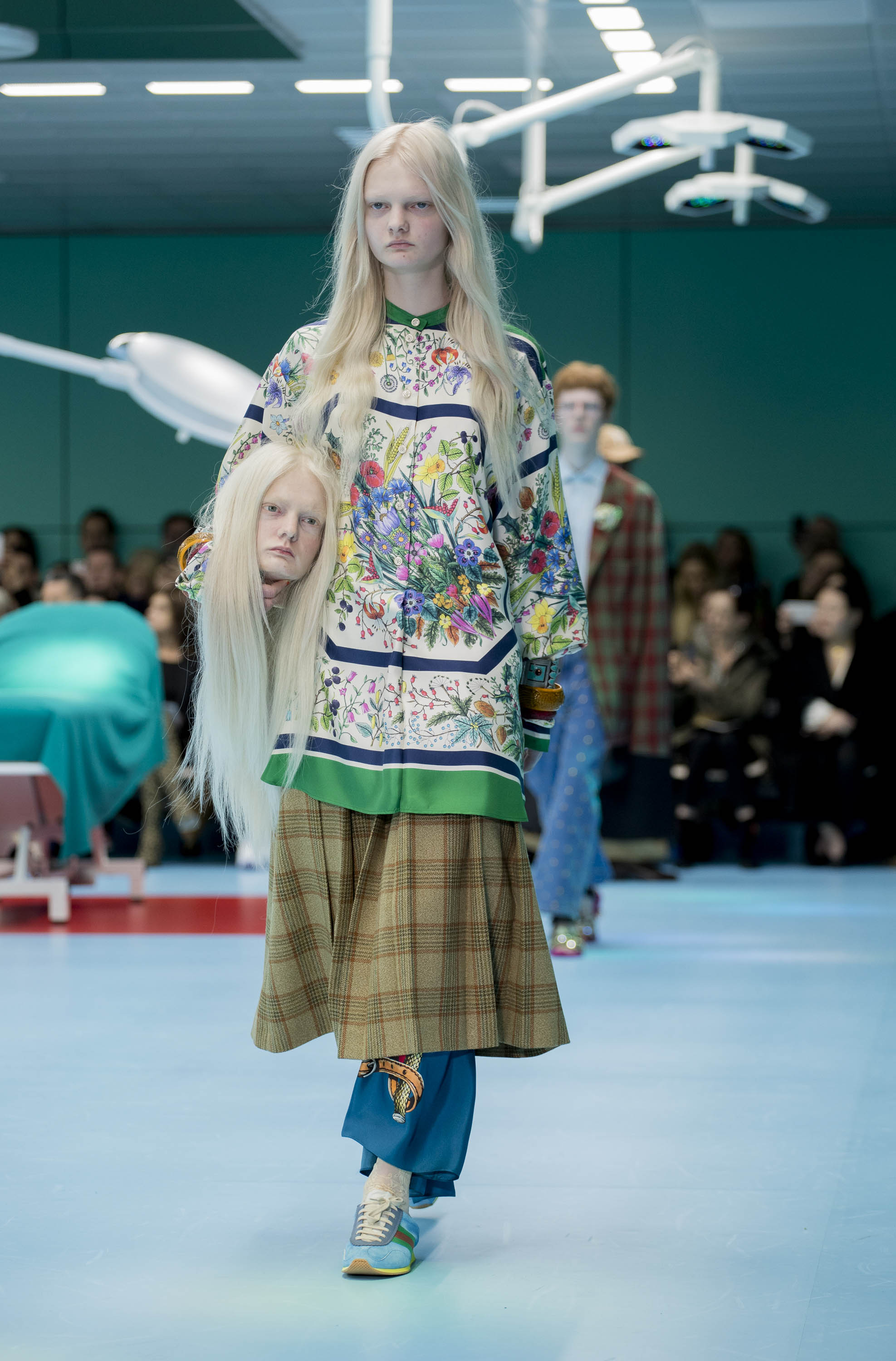 Gucci AW18  Alessandro Michele’s maximalist style transformed the fortunes of Gucci in a few short years. For his 2018 Autumn/Winter offering, he reimagined Milan’s Gucci hub into a surgeon’s operating room, complete with harsh overhead lighting, green panelled walls and plastic waiting-room chairs. With Donna Haraway’s A Cyborg Manifesto as inspiration, models carried lifelike replicas of their own heads down the catwalk, as well as a realistic looking snake, iguana and baby dragon. These otherworldly creations took six months to make in collaboration with Makinarium, a Rome-based physical and visual special effects centre. Sam Deaman