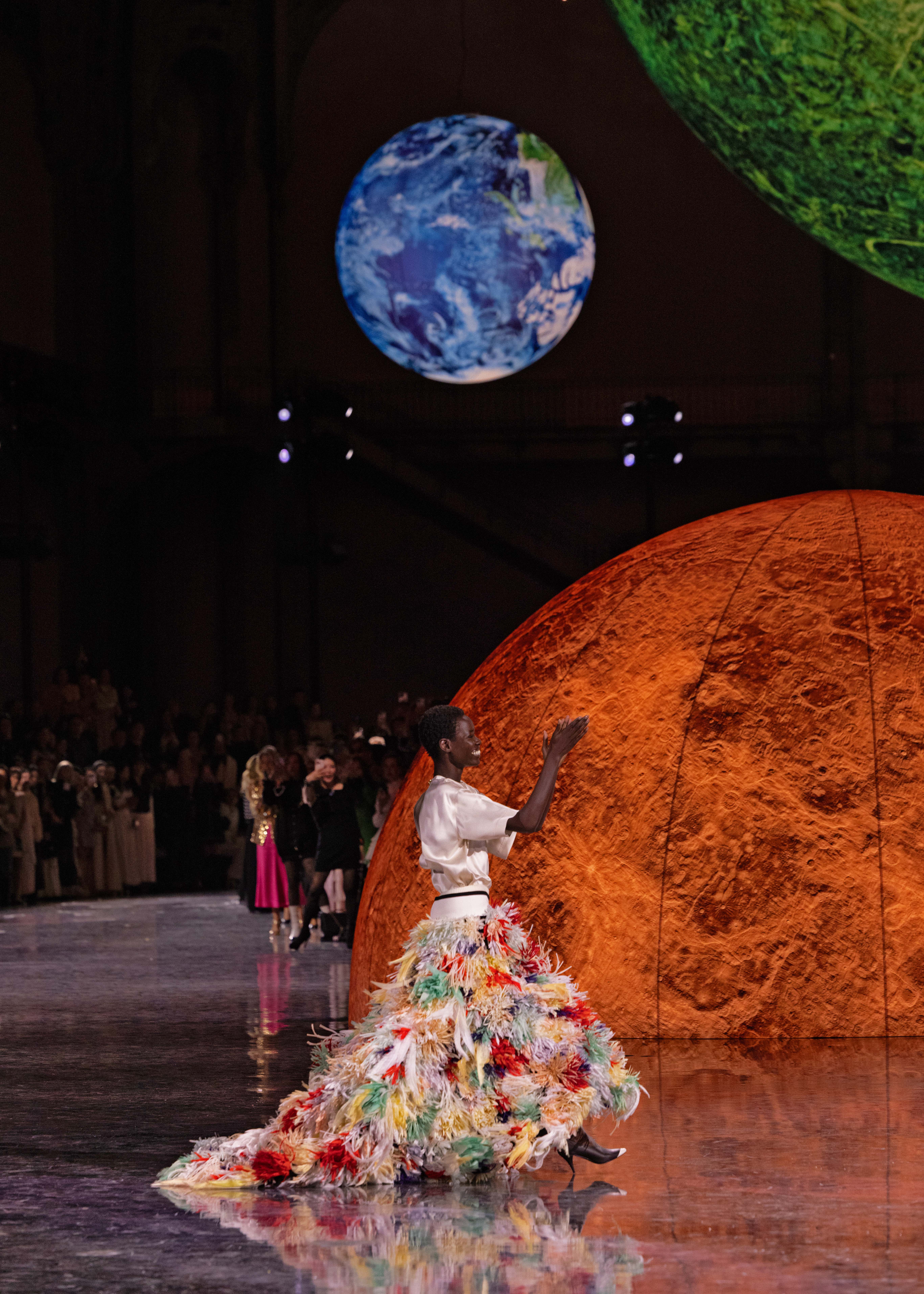Model Awar Odhiang closes the show in a gown with a carnival skirt of silk and feather flowers