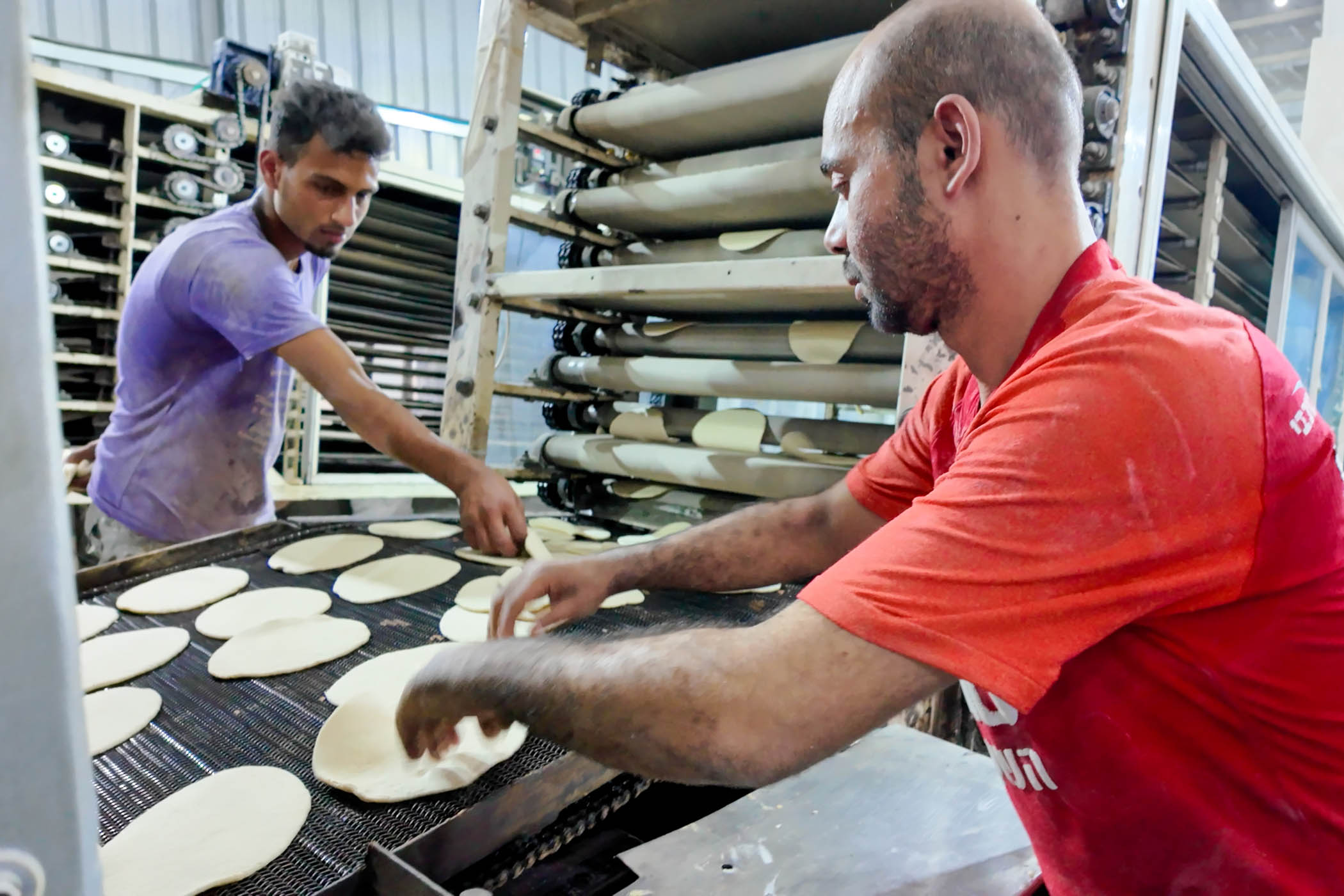 Under the ceasefire, workers at the Castle Bakery produce up to 300,000 pitta breadsa day