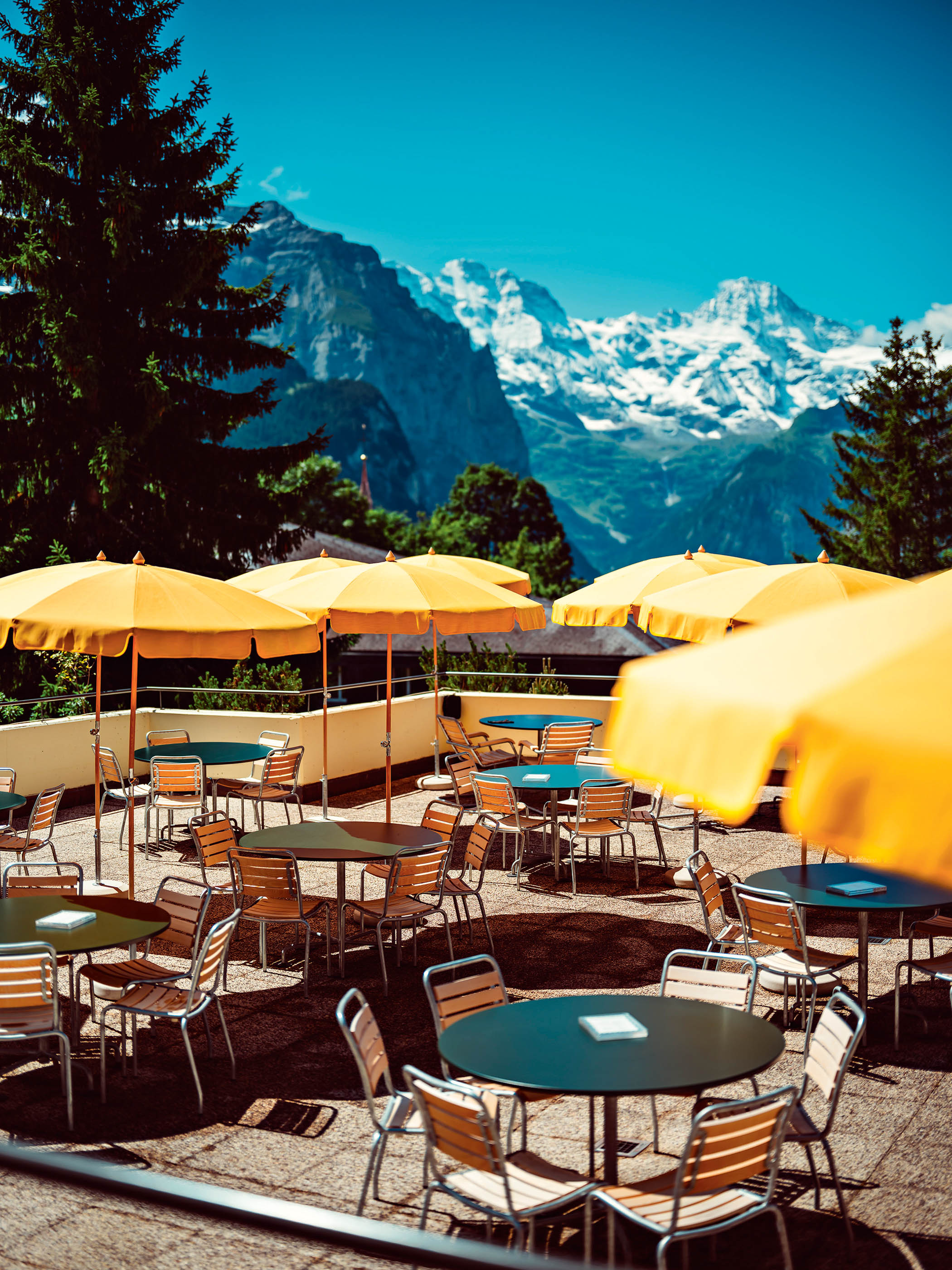 Holidays with altitude: yellow sun parasols on the terrace at Sonnenbad
