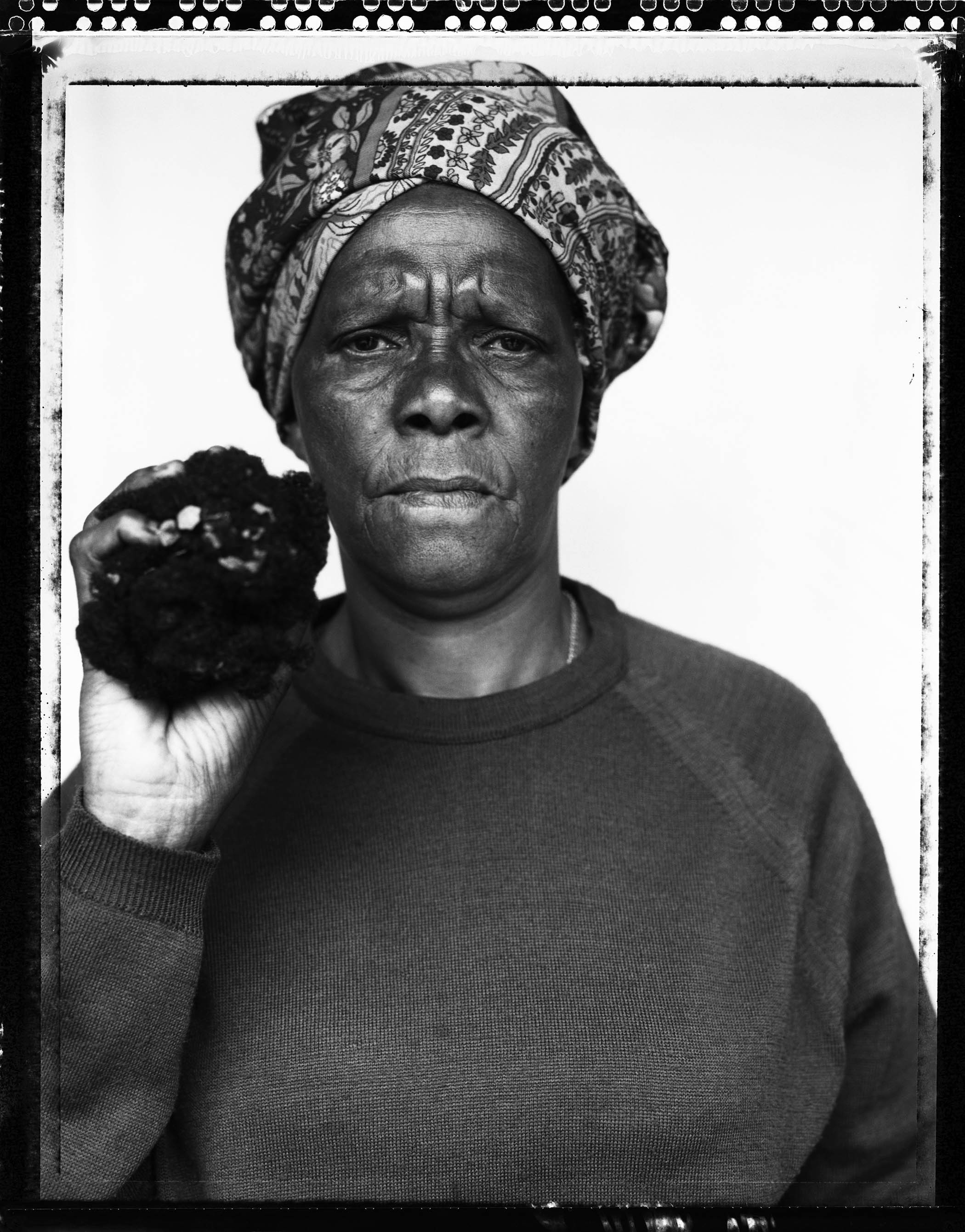 Joyce Mtimkulu holding hair that once belonged to her murdered son, Siphiwo