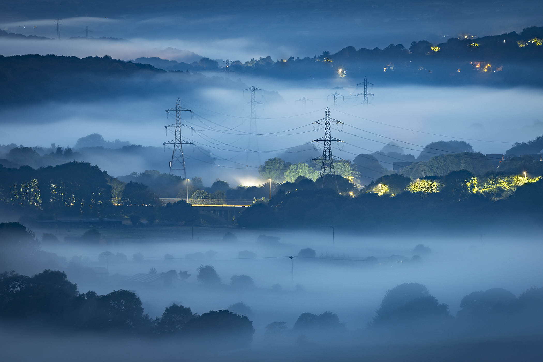 Pylons rise through the mist in Leeds