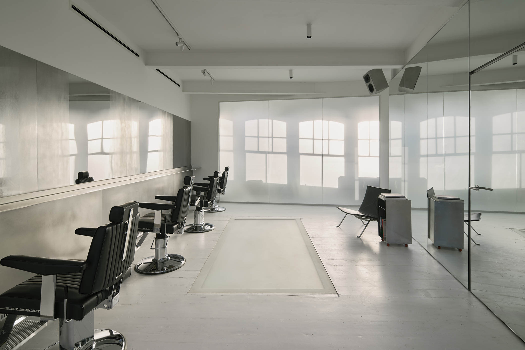 The cutting floor at Salt Salon. Main image: the listening room, with speakers built into the steel structure on the left