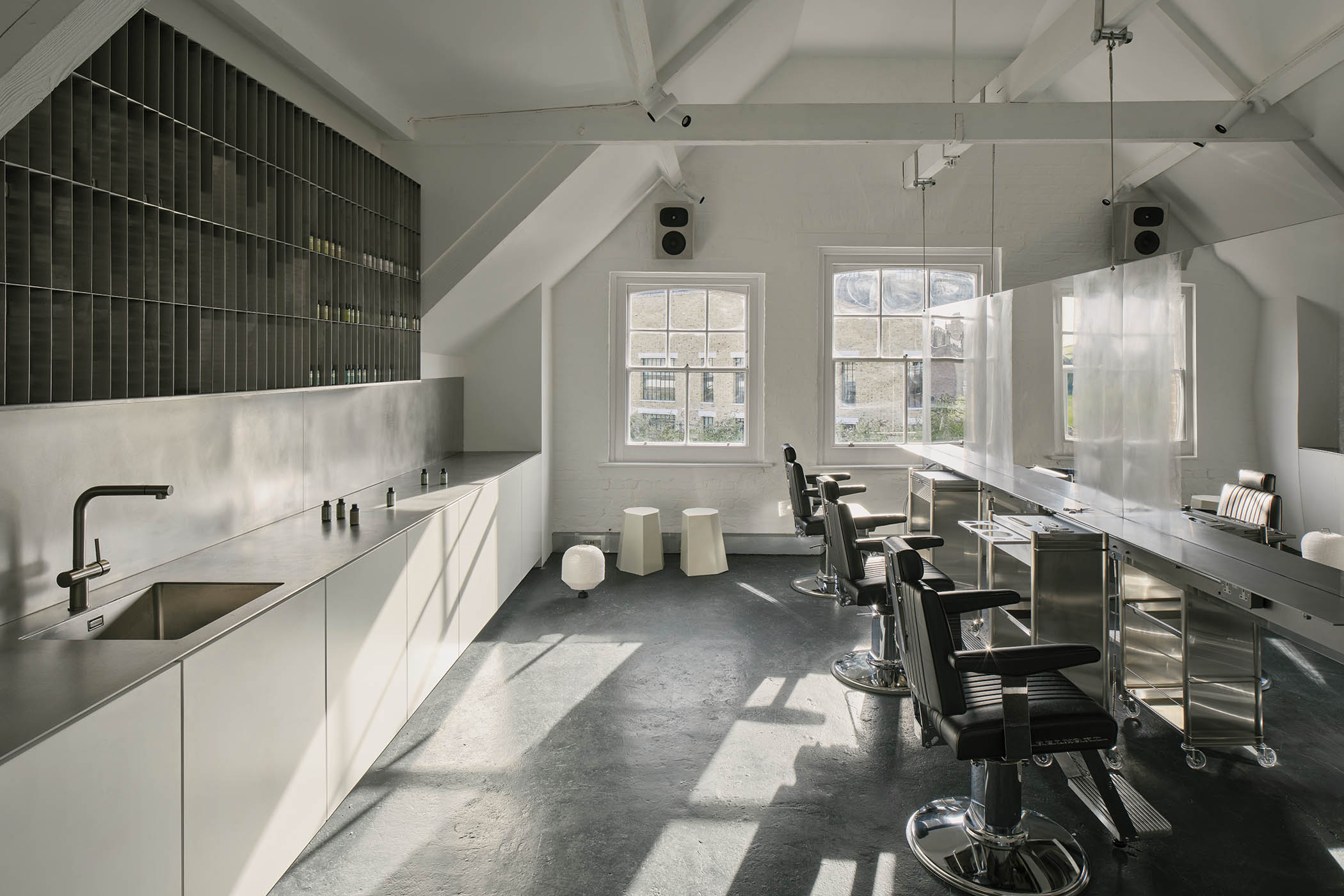 The colour floor at Salt Salon where a half-tonne sculptural mirror workstation hangs from the timber rafters of the old building