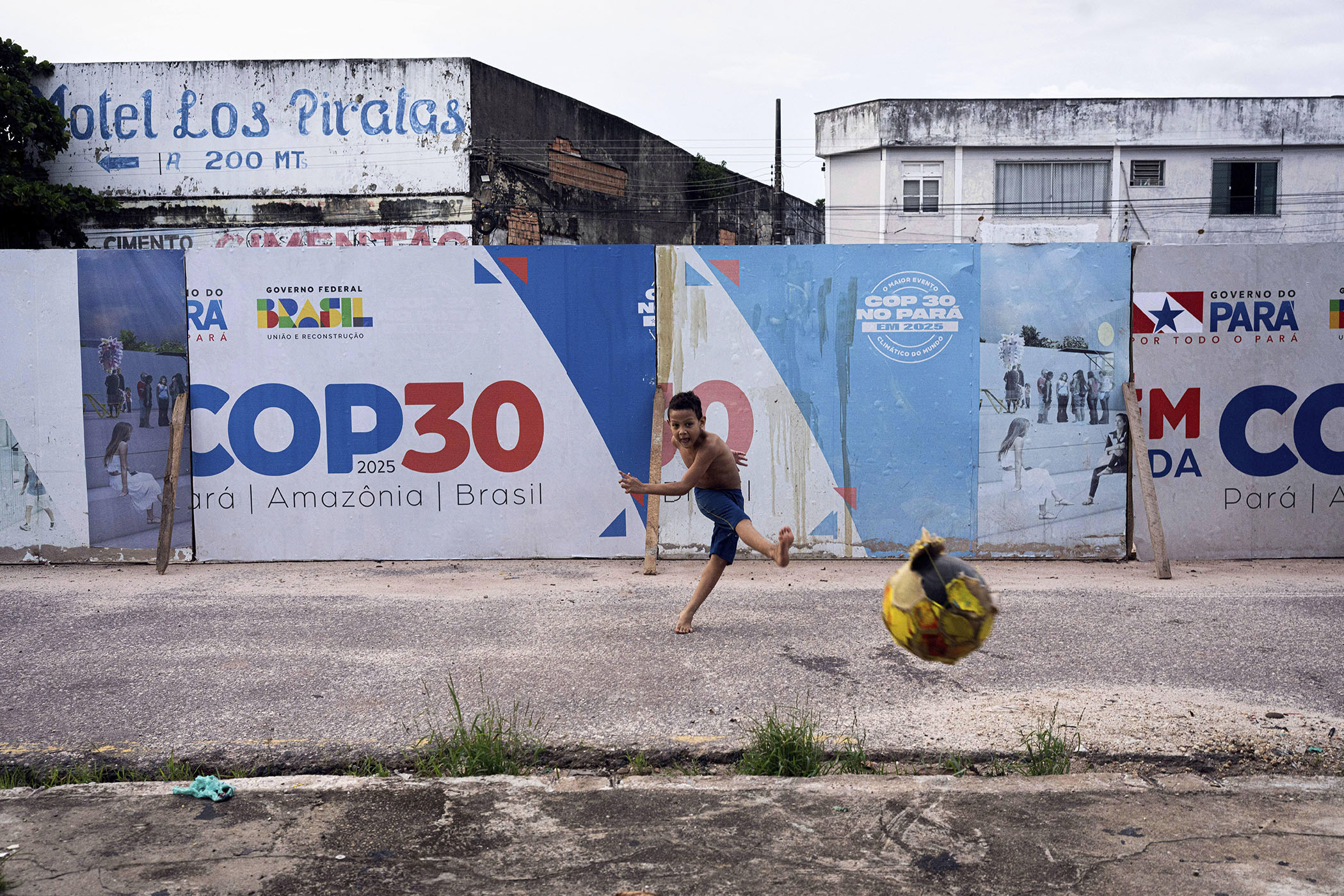 A boy kicks a soccer ball in Belem, Brazil ahead of the Cop summit there this week