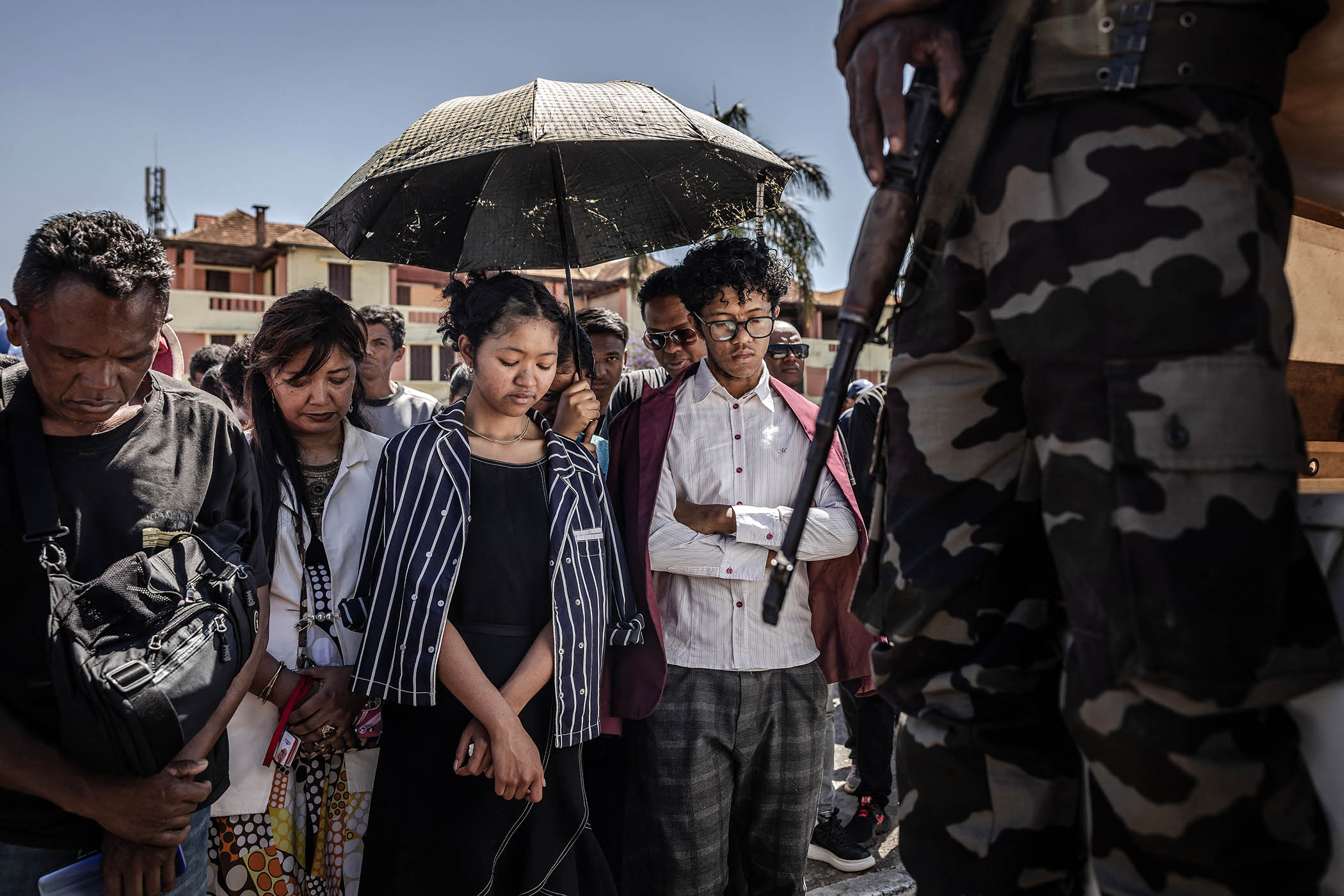 Residents observe a minute of silence to honour protesters killed in anti-government demonstrations in Antananarivo on 12 October 2025