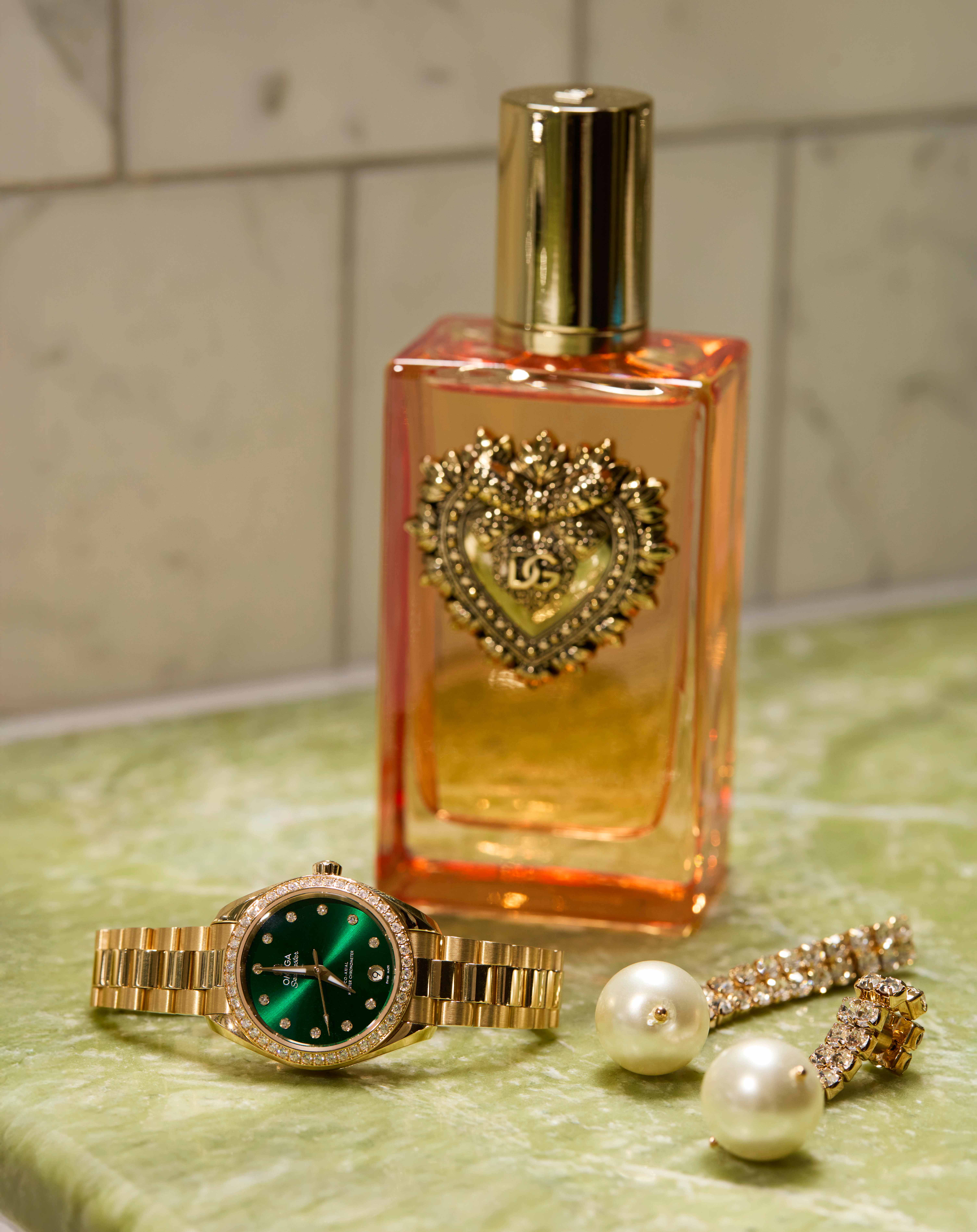 Seamaster Aqua Terra watch, price on request, Omega. Devotion fragrance by Dolce & Gabbana, £147, Harrods. Earrings, £17.99, Mango