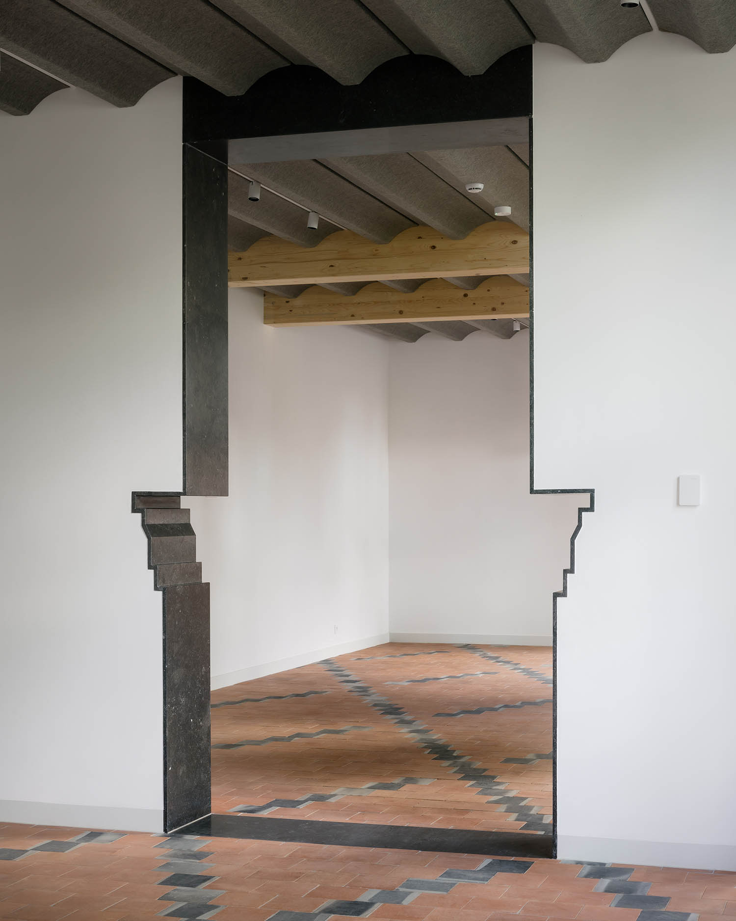 Inside the beguinage, a doorway now stands in place of an old mantelpiece