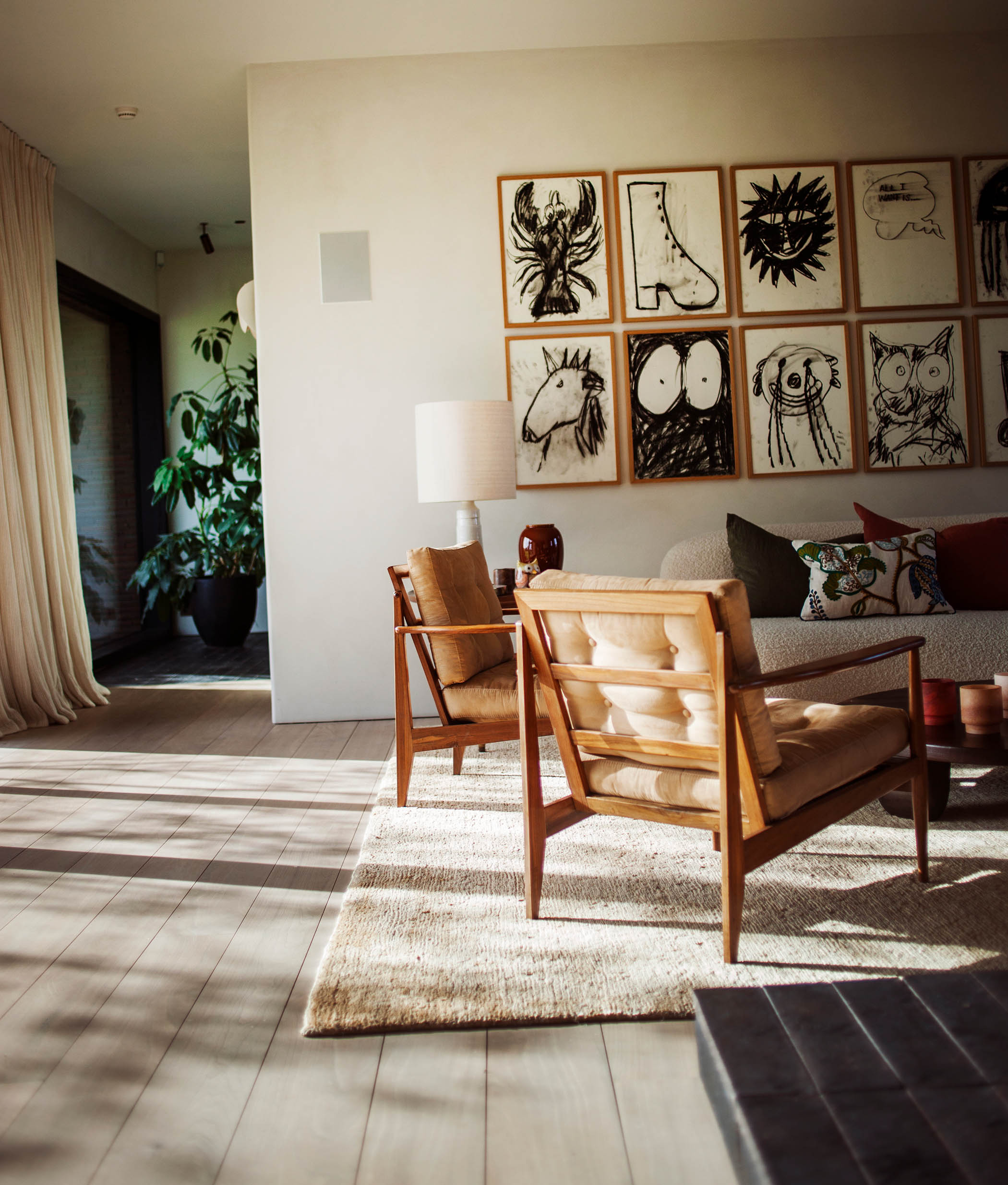 In the Belgian style: brushed-concrete floors in the living space, a cosy carpet and charcoal drawings by Cameron Platter