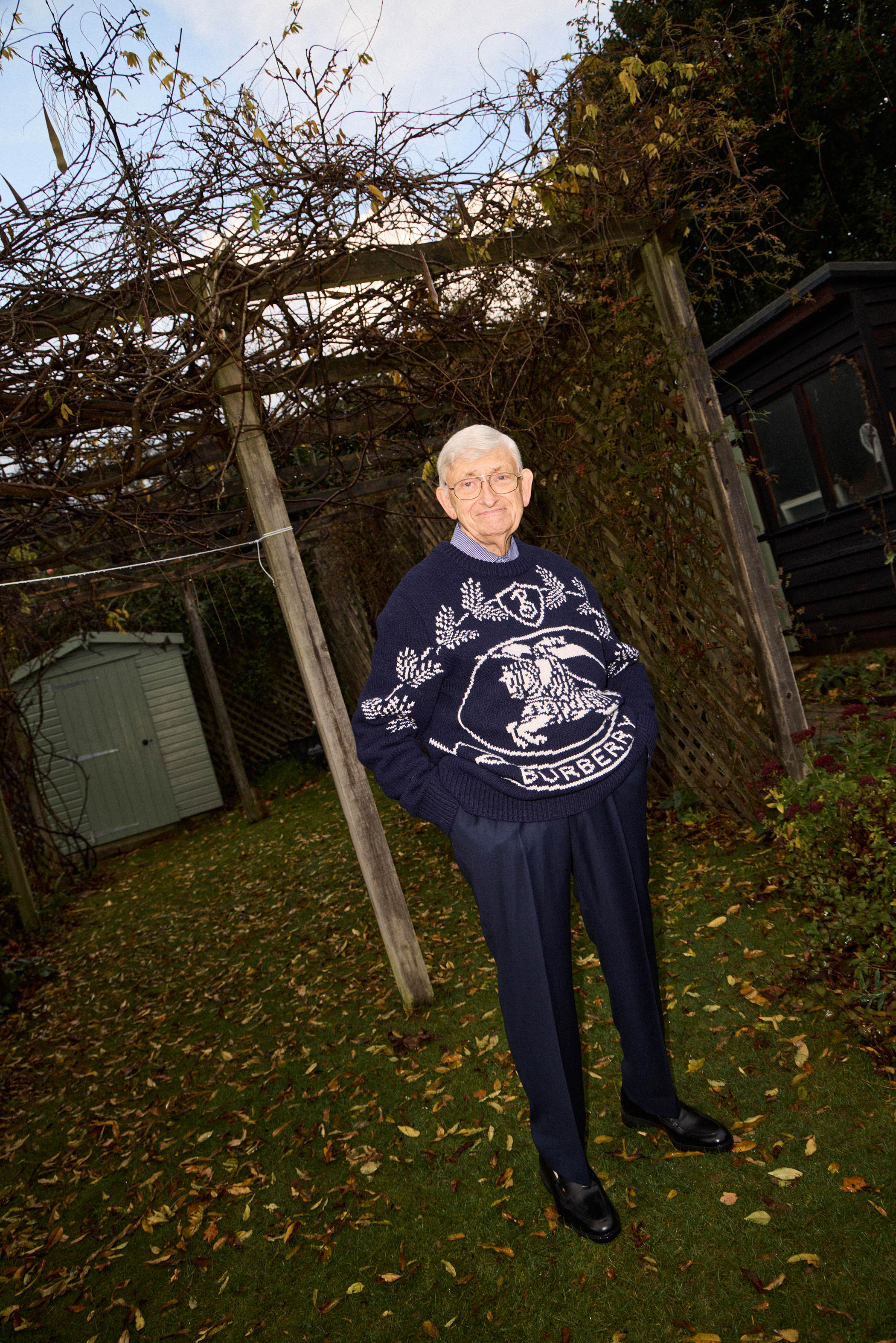 Michael wears knitted jumper £490, pre-loved by Burberry from Designer Exchange; navy trousers, £99, by John Lewis; and penny loafers, £705, Santoni