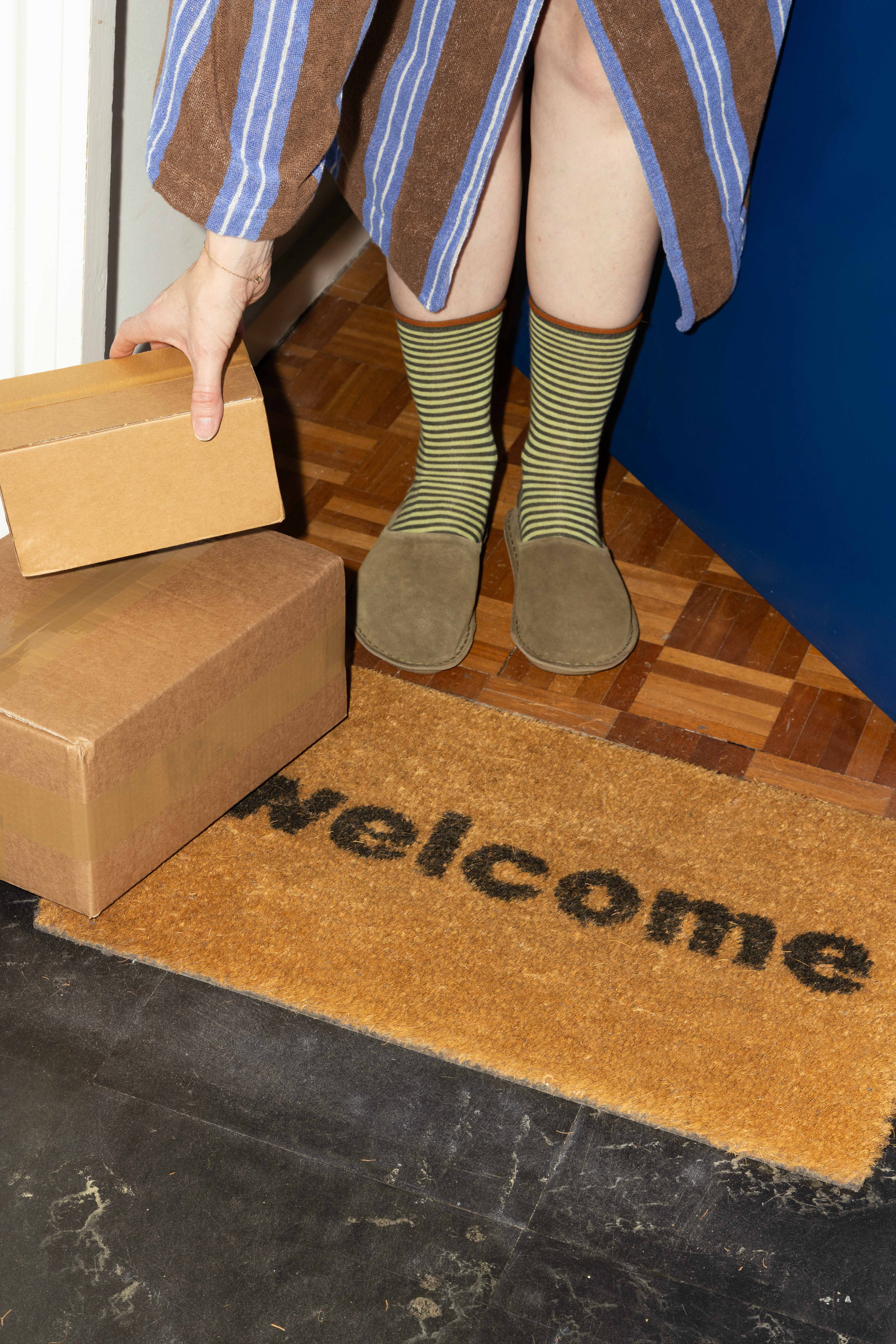 Return to senderHooded bathrobe, £225, Tekla. Striped cotton cashmere socks, £25, and Vibae Roma mules, £135, both Toast