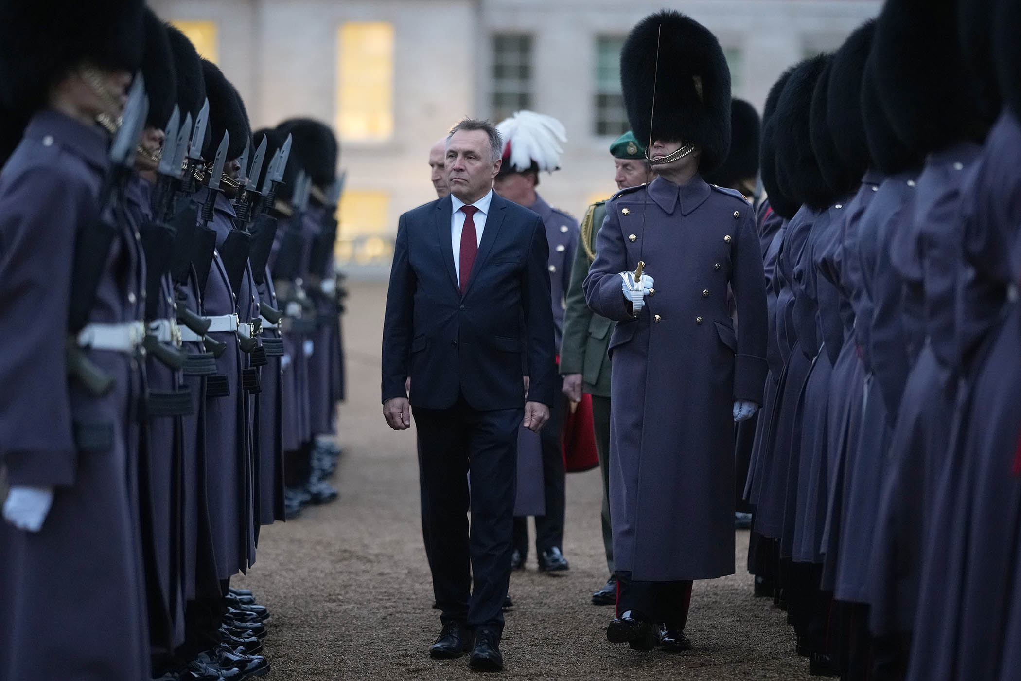 Norway's minister of defence Tore Sandvik inspects a guard of honour at Horse Guards Parade, London on 4 December