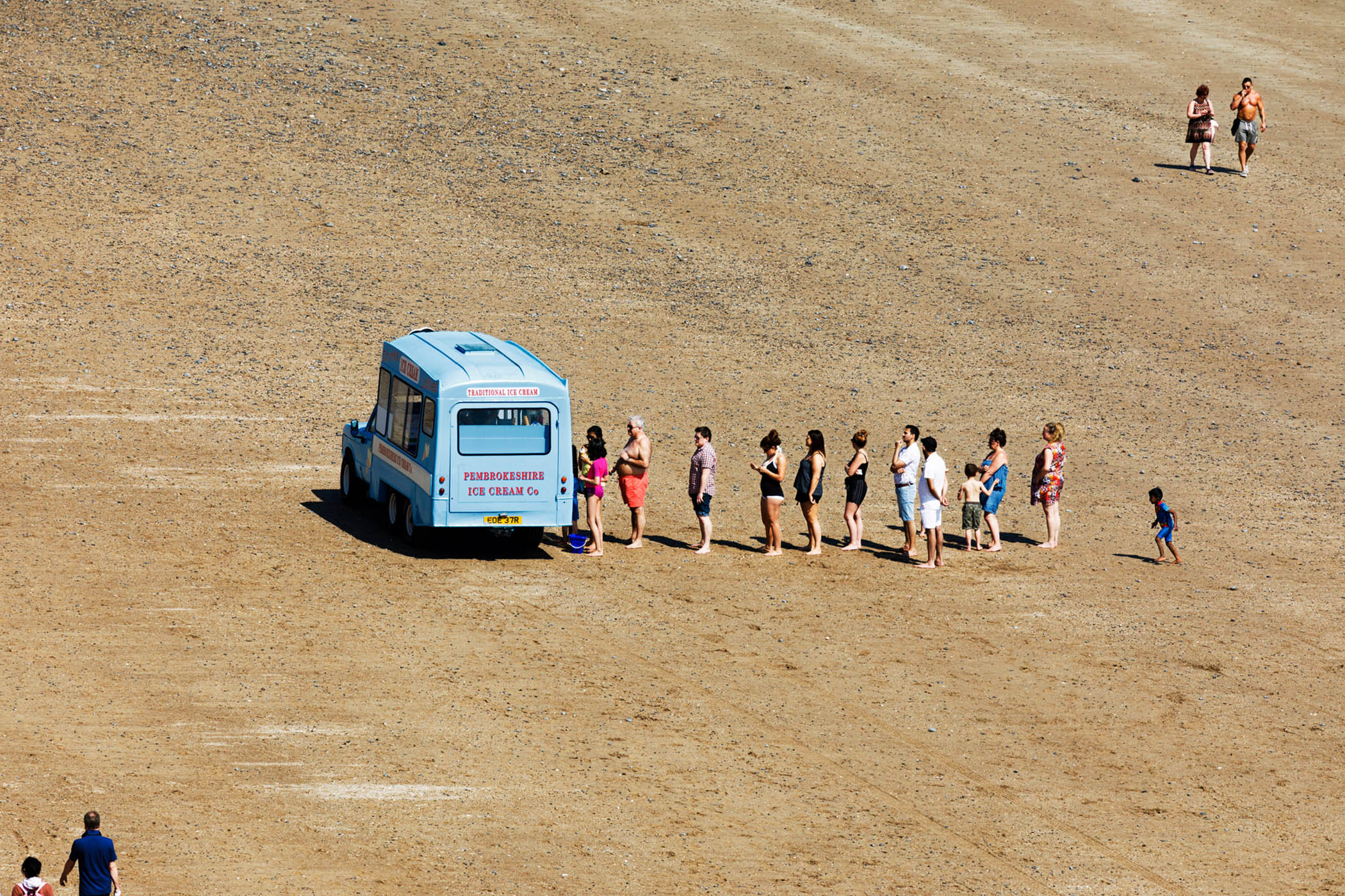 Beachgoers queueing for ice cream in Tenby, 2018