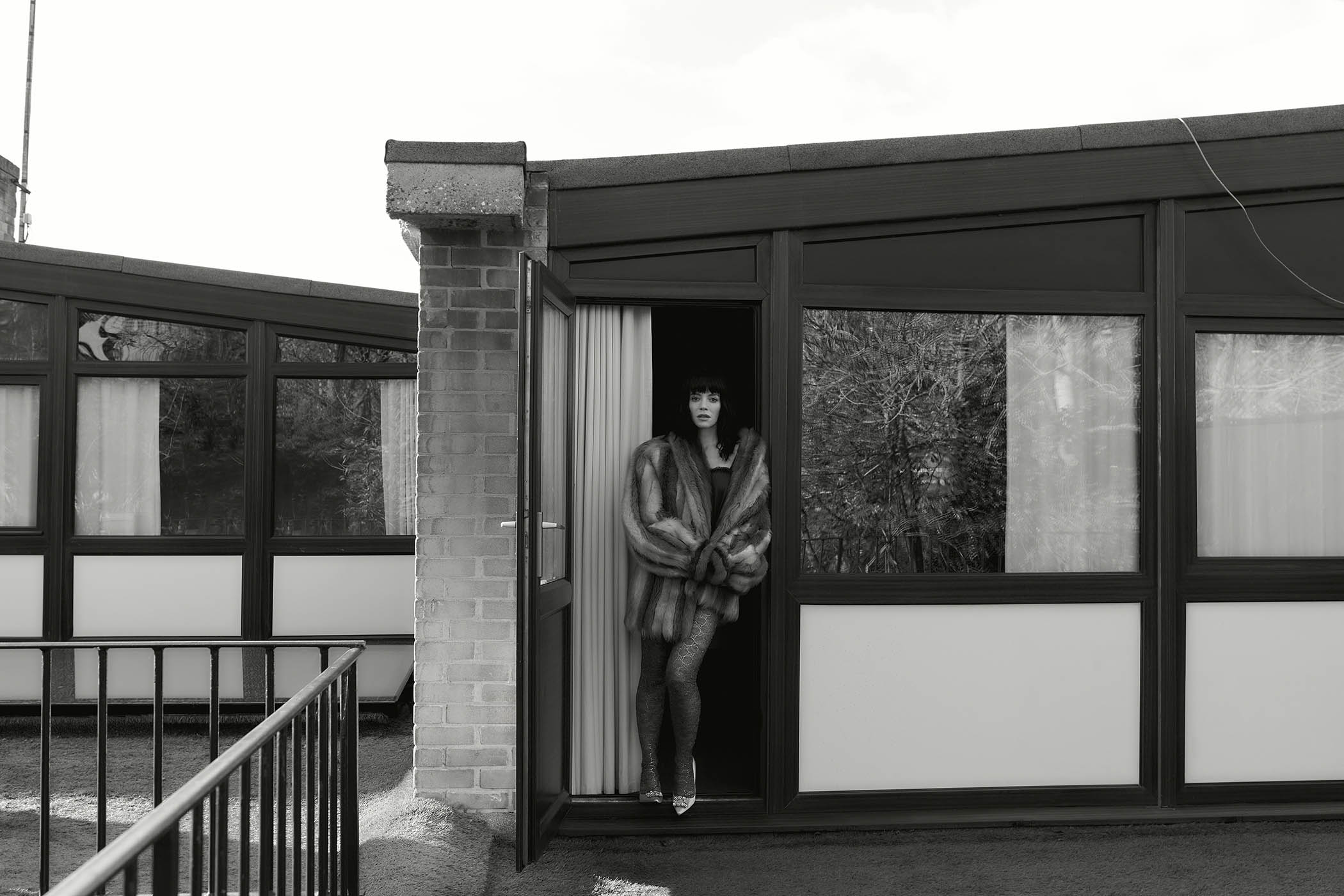 Shearling coat, silk satin all-in-one lingerie with ruffled belt and laced stockings, all by Gucci; and efflorescence pumps by Roger Vivier