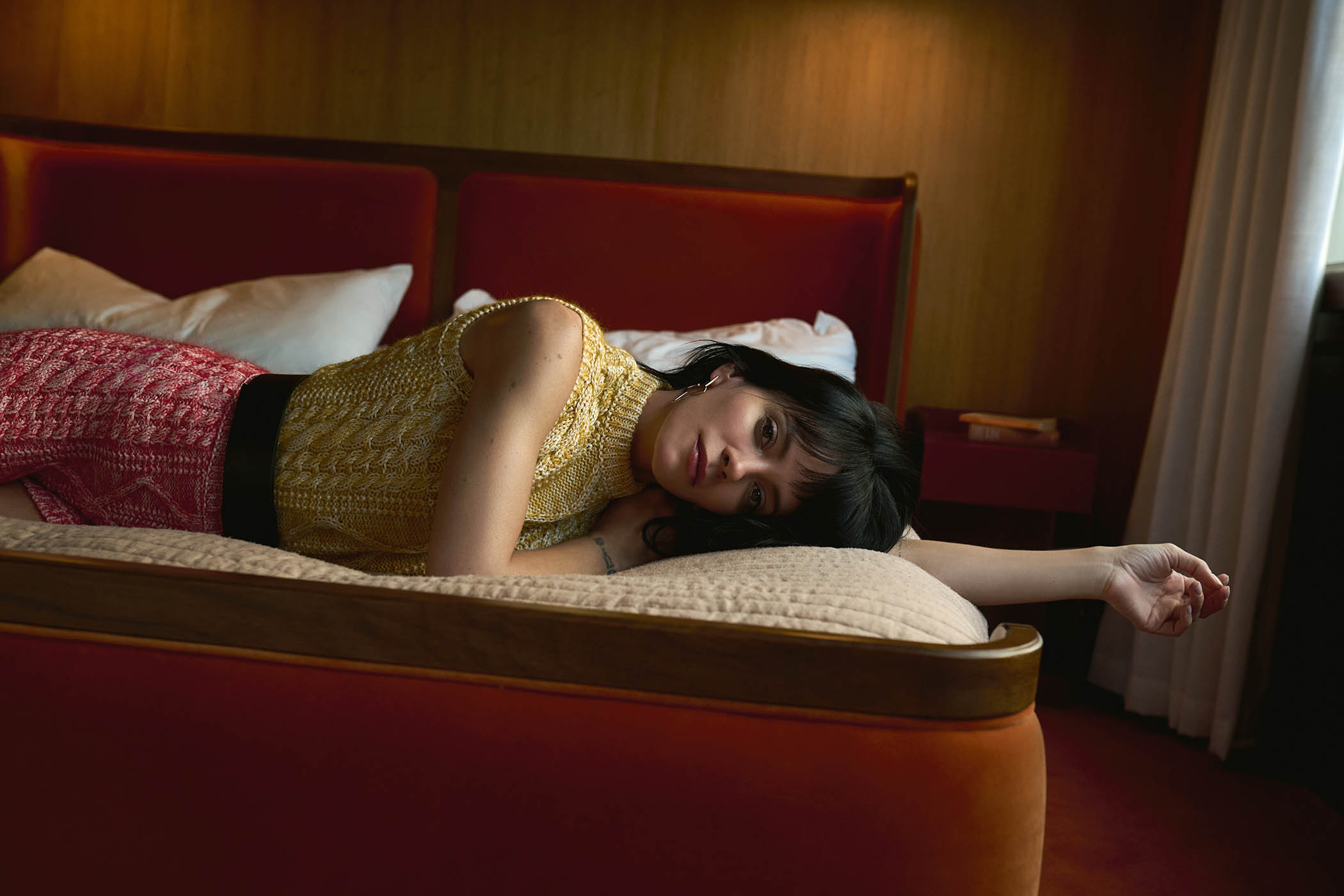 Sleeveless cable knit jumper, shorts, leather belt, and blossom hoop earrings, all by Louis Vuitton