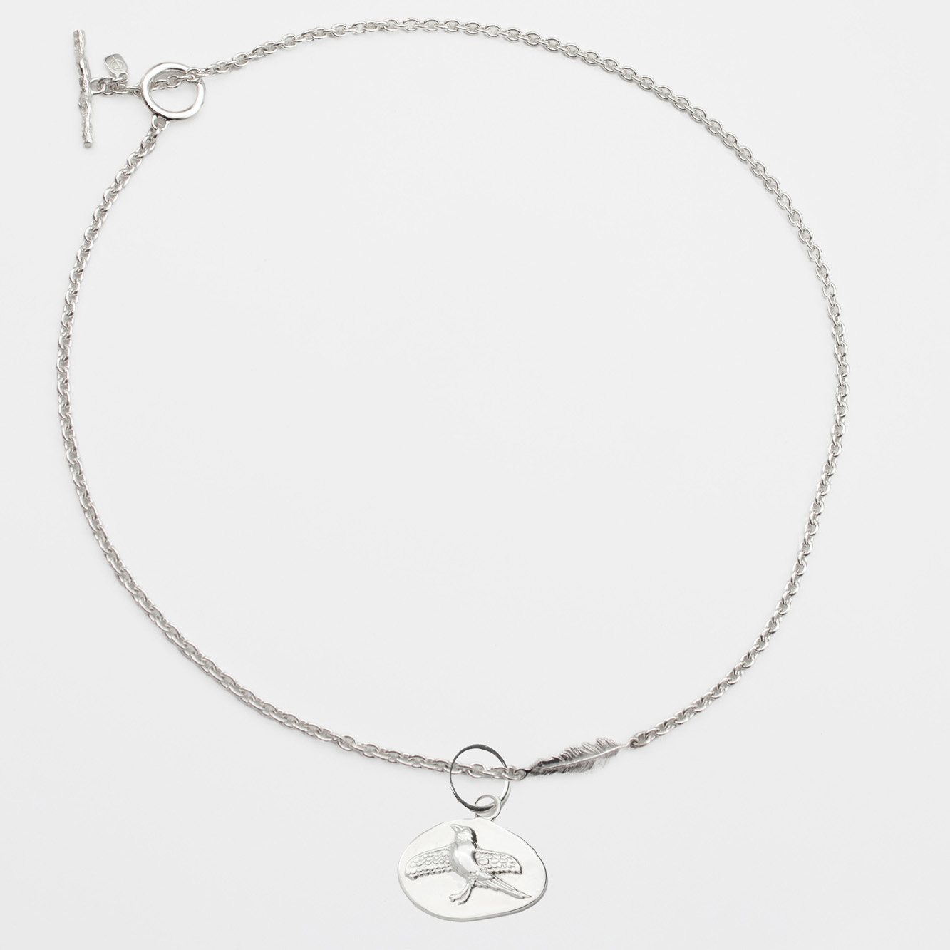 Feather chain necklace £204.42 and Magpie pendant £73.33, both O.P Jewellery x Ragnar Persson