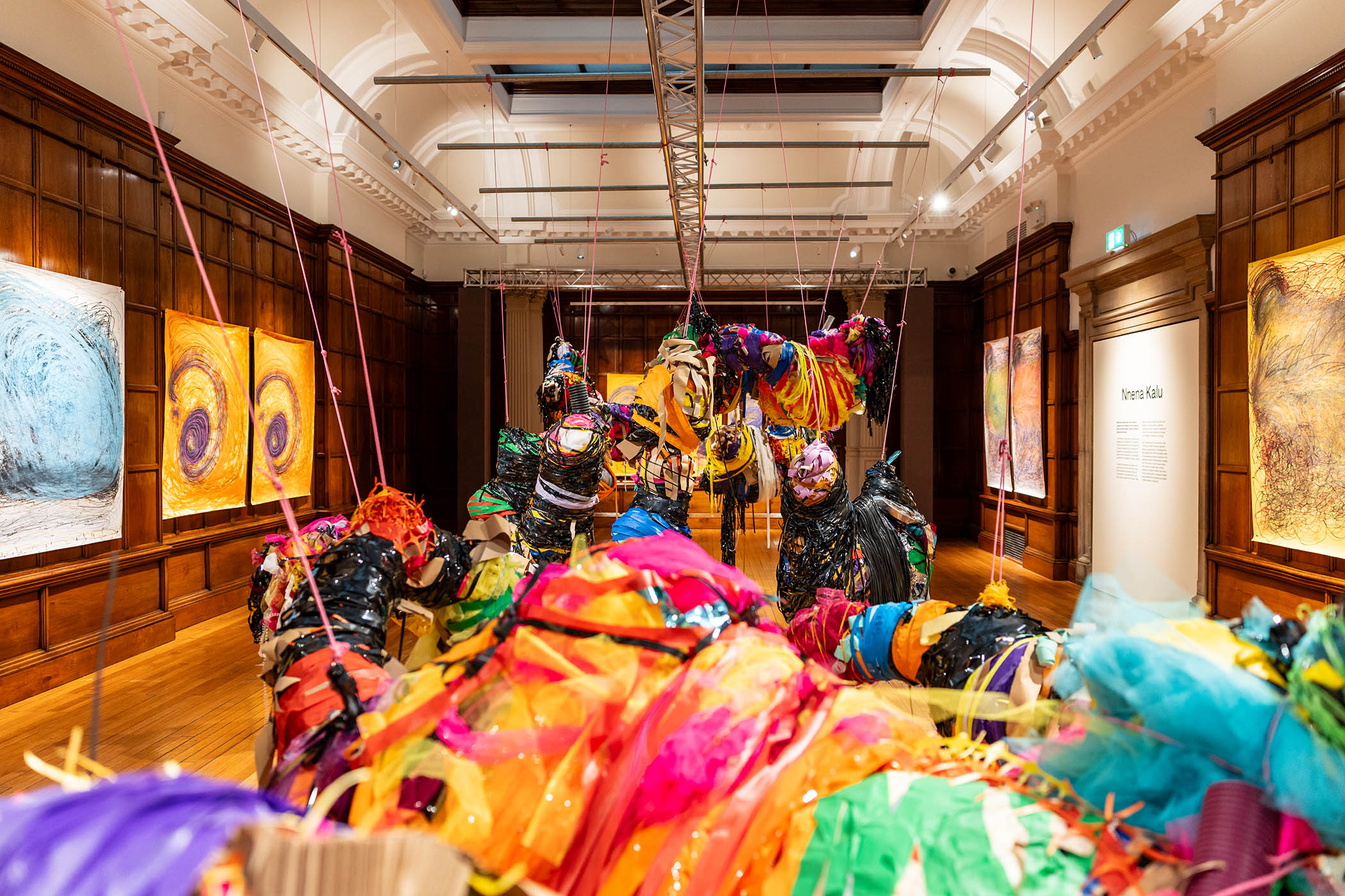 Works by Nnena Kalu go on display during the Turner prize 2025 exhibition. Main image: the artist in front of one of her expressive charcoal canvases