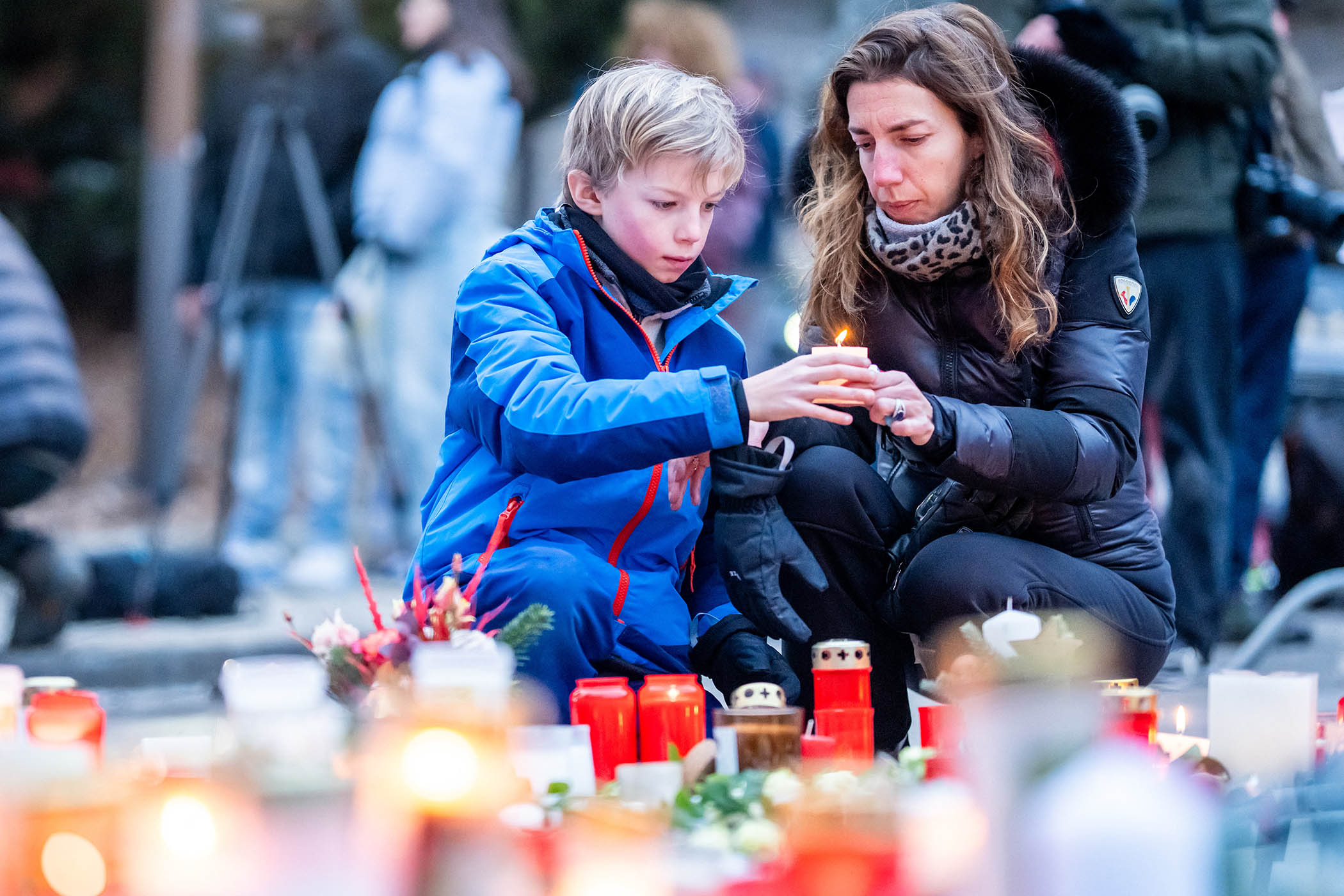 Mourners lay candles near the Le Constellation bar