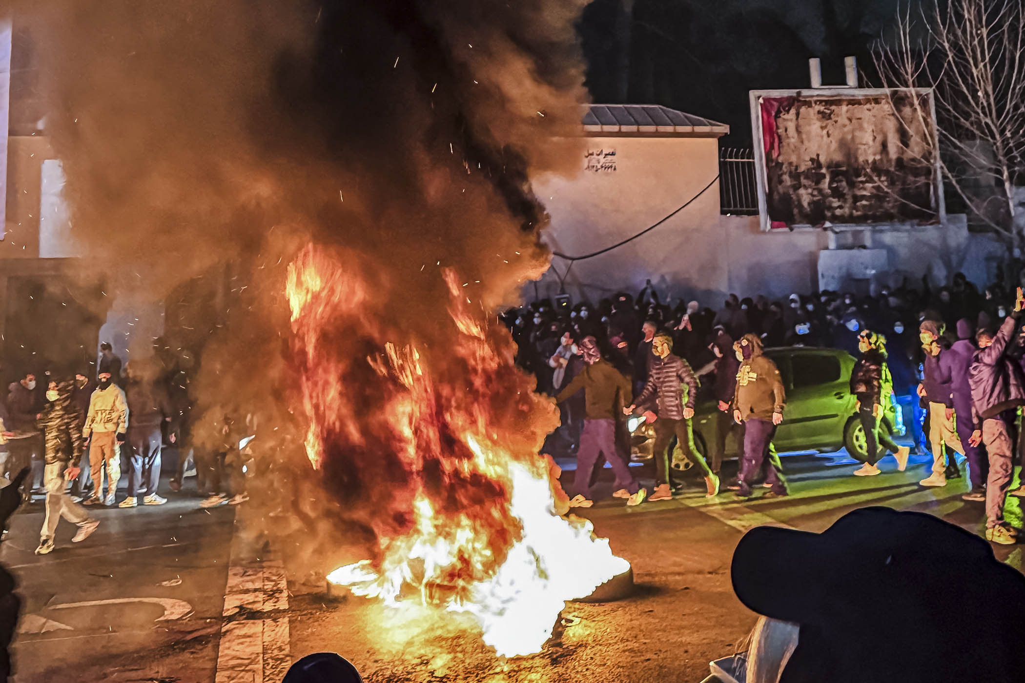 Iranians gather while blocking a street during a protest in Tehran on 9 January, 2026