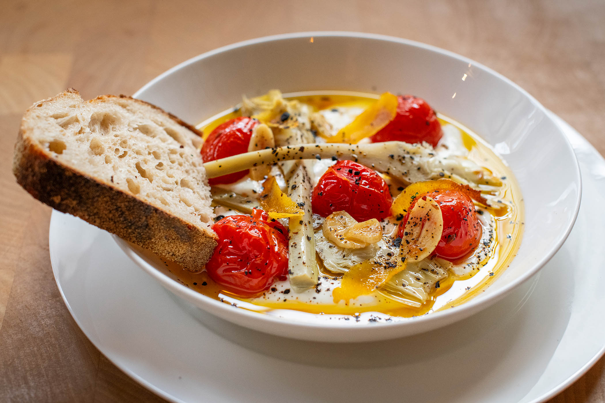 Spice it up: whipped Greek yoghurt, roasted cherry tomatoes with cumin, lemon, garlic, oregano, urfa chilli and marinated artichokes