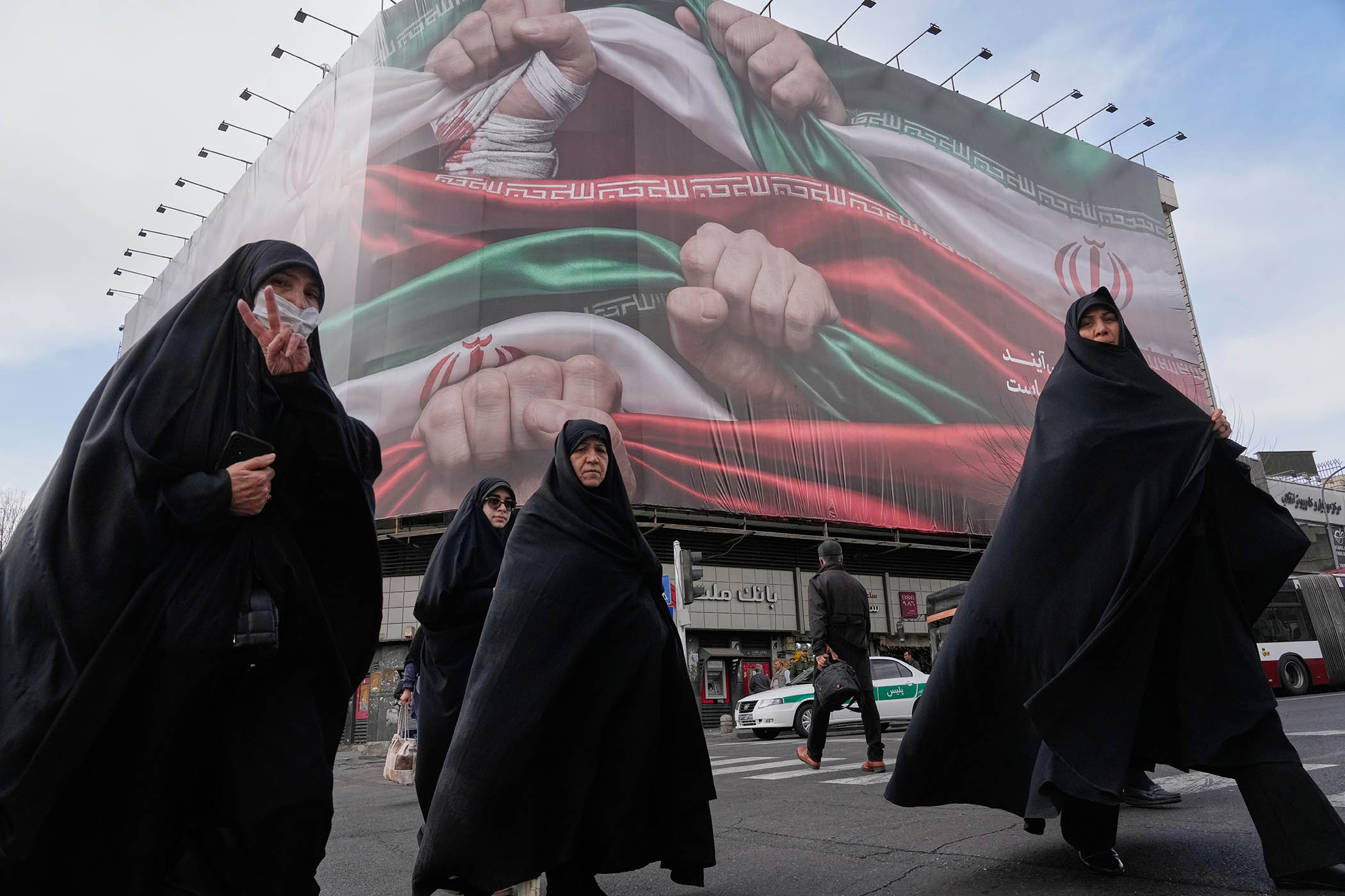 A woman flashes a victory sign in Tehran on Wednesday