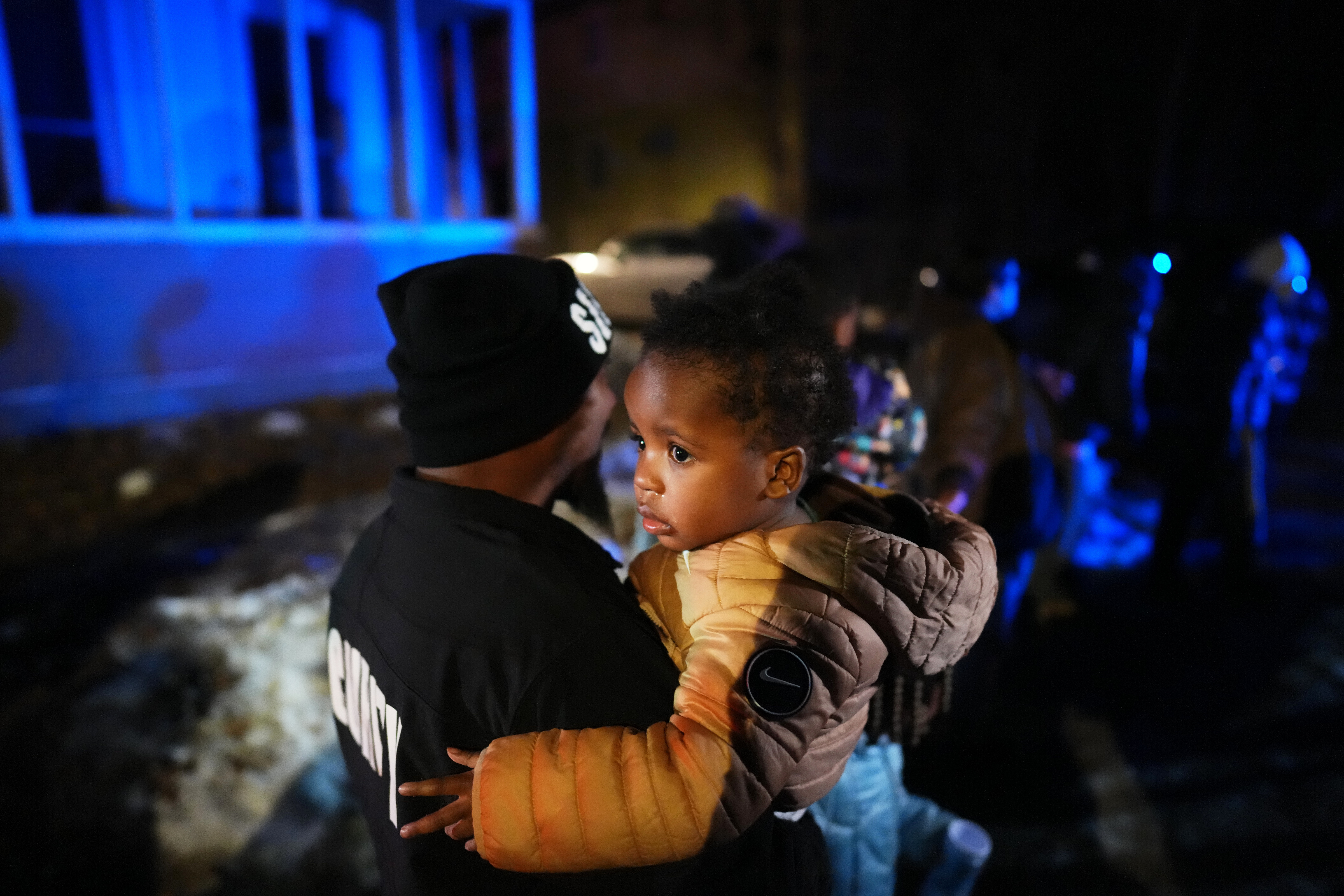 A child and her family are escorted away after ICE agents deployed teargas during a protest on 14 January