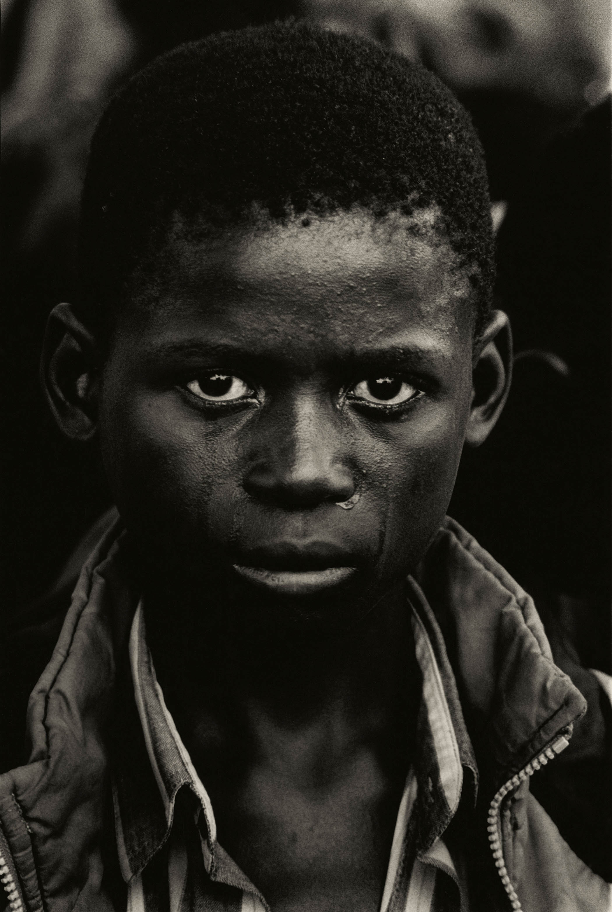 A Zambian boy crying at the funeral for his father, who died from Aids, in 2000
