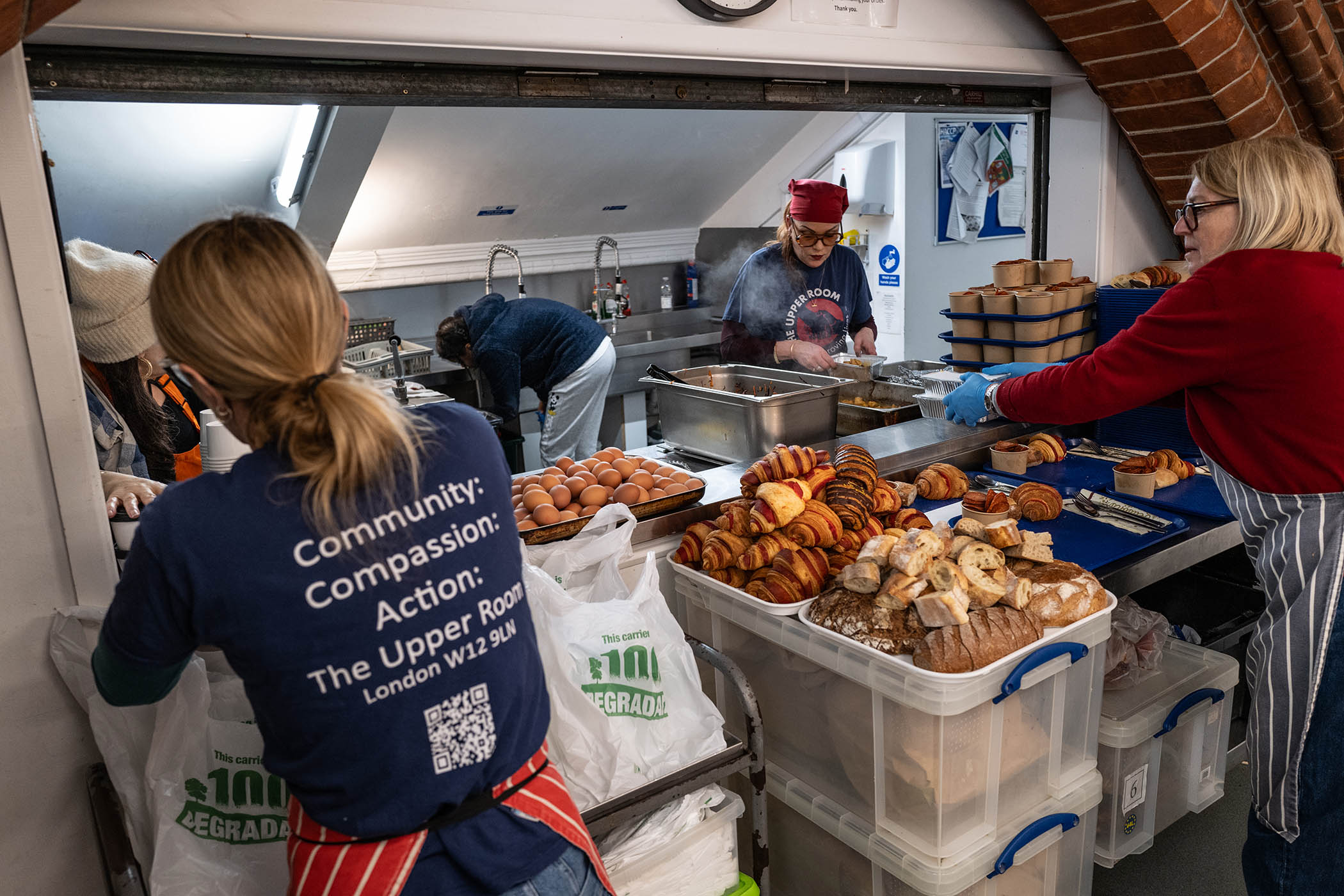 Volunteers at the charity the Upper Room prepare evening meals at its HQ in west London