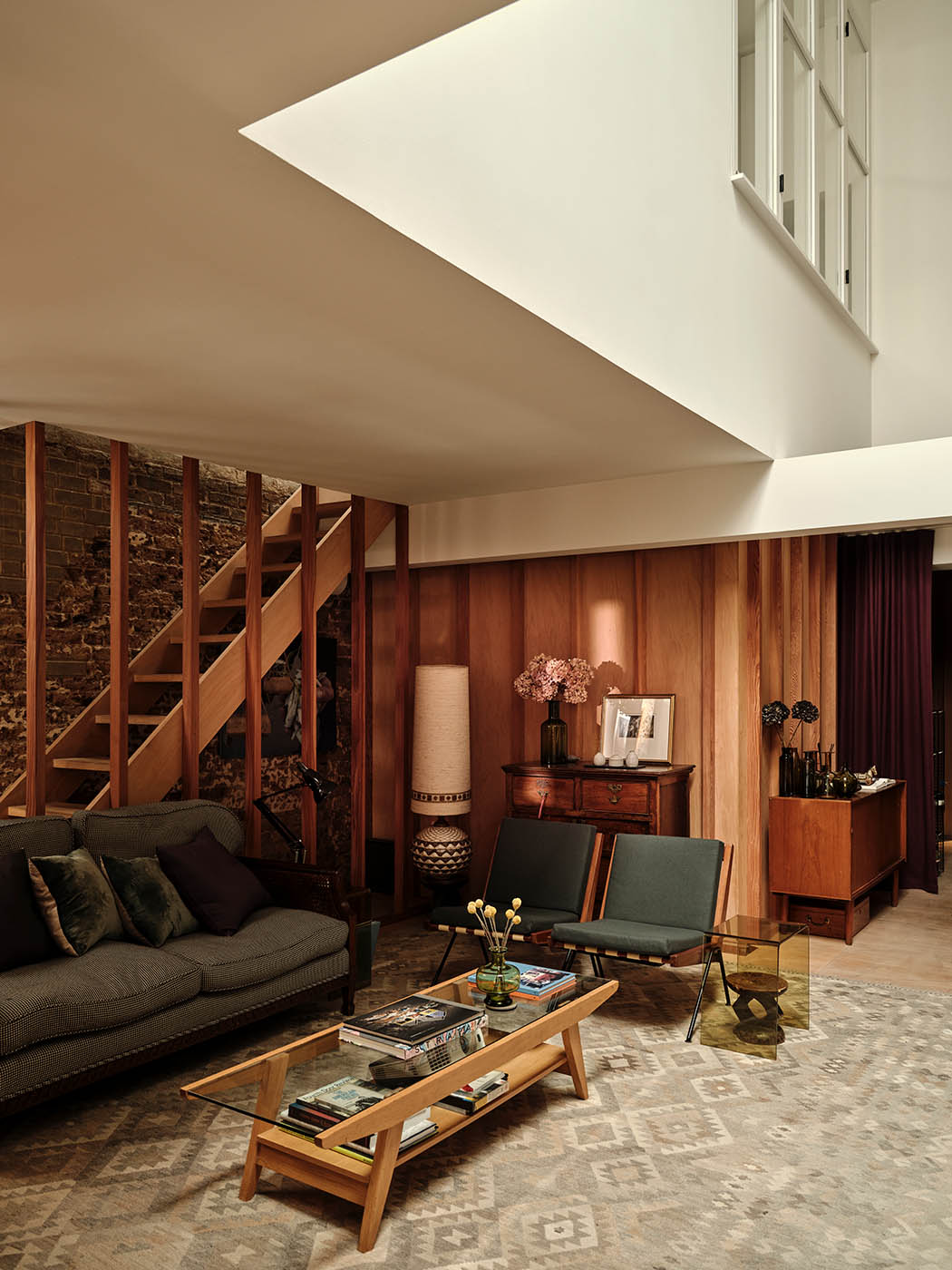 Another level: wooden stairs lead from the sitting room up to the guest bedroom