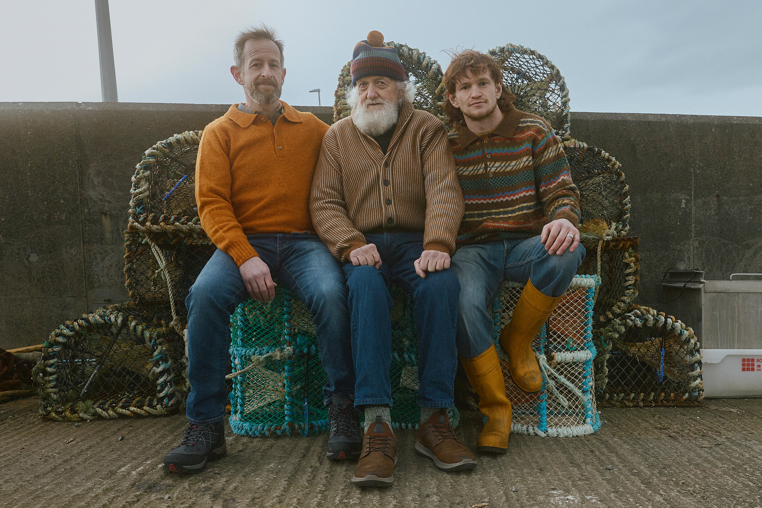 Sandy, Seamus Sr and Seamus Jr McKinnon: the three generations of the McKinnon family run Misty Isle Boat Trips, established in 1968 and based in Elgol on the Isle of Skye. From left: Sandy, 48, wears Shetland polo by Kestin; Seamus Sr, 79, wears cashmere cardigan by Begg x Co, and bobble hat by Howlin’; Seamus Jr, 26, wears polo by Howlin’