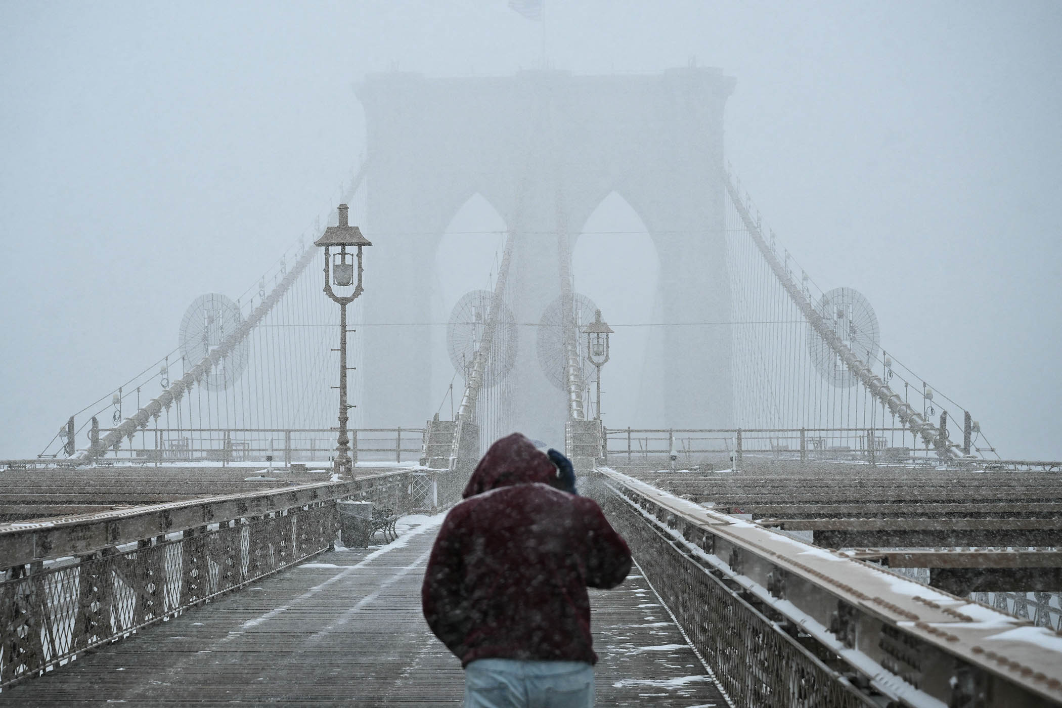 Winter weather obscures the Brooklyn Bridge on 25 January