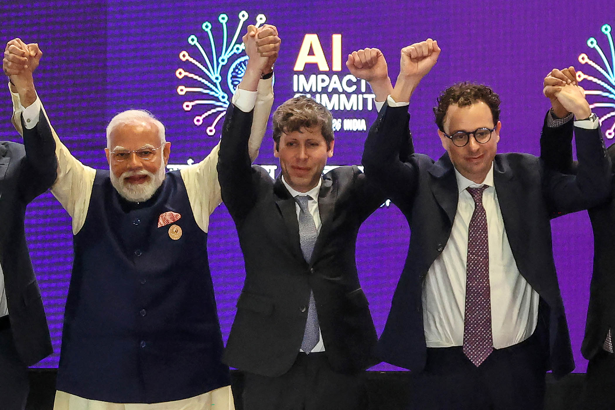 Sam Altman, centre, and Dario Amodei appear to decline to join hands at the recent India AI Impact summit