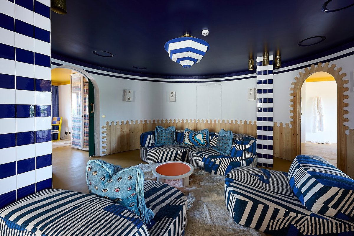 At JNcQUOI Comporta, opening 2028, the Deli Suite features modular blue sofas and traditional tiling