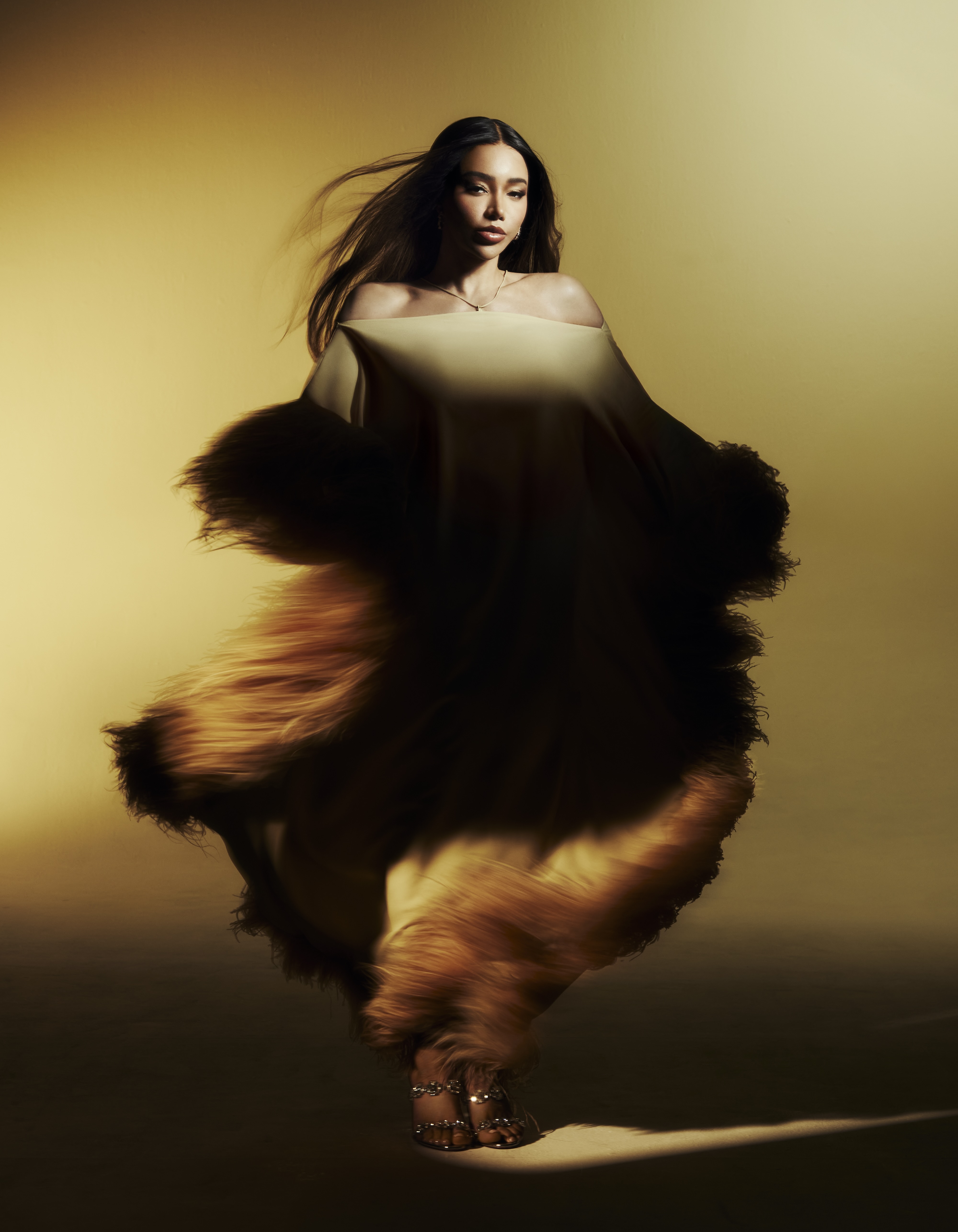 Mellow yellow: Munroe Bergdorf wears Extravaganza kaftan by Taller Marmo; and jewel sandals by Christian Louboutin