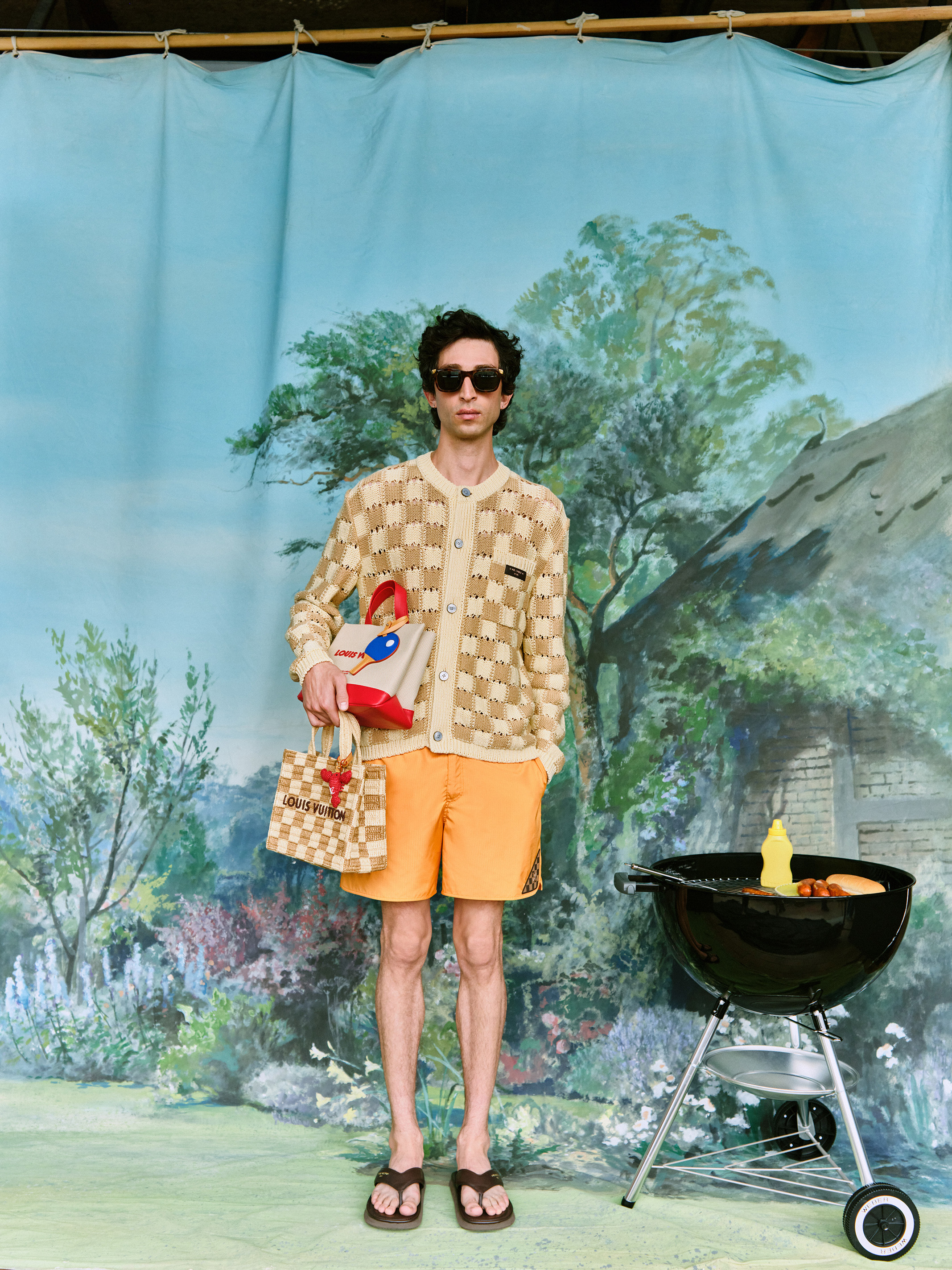 Sunglasses, check cardigan, swim shorts, sandals and bags all by Louis Vuitton; barbecue by Weber at John Lewis