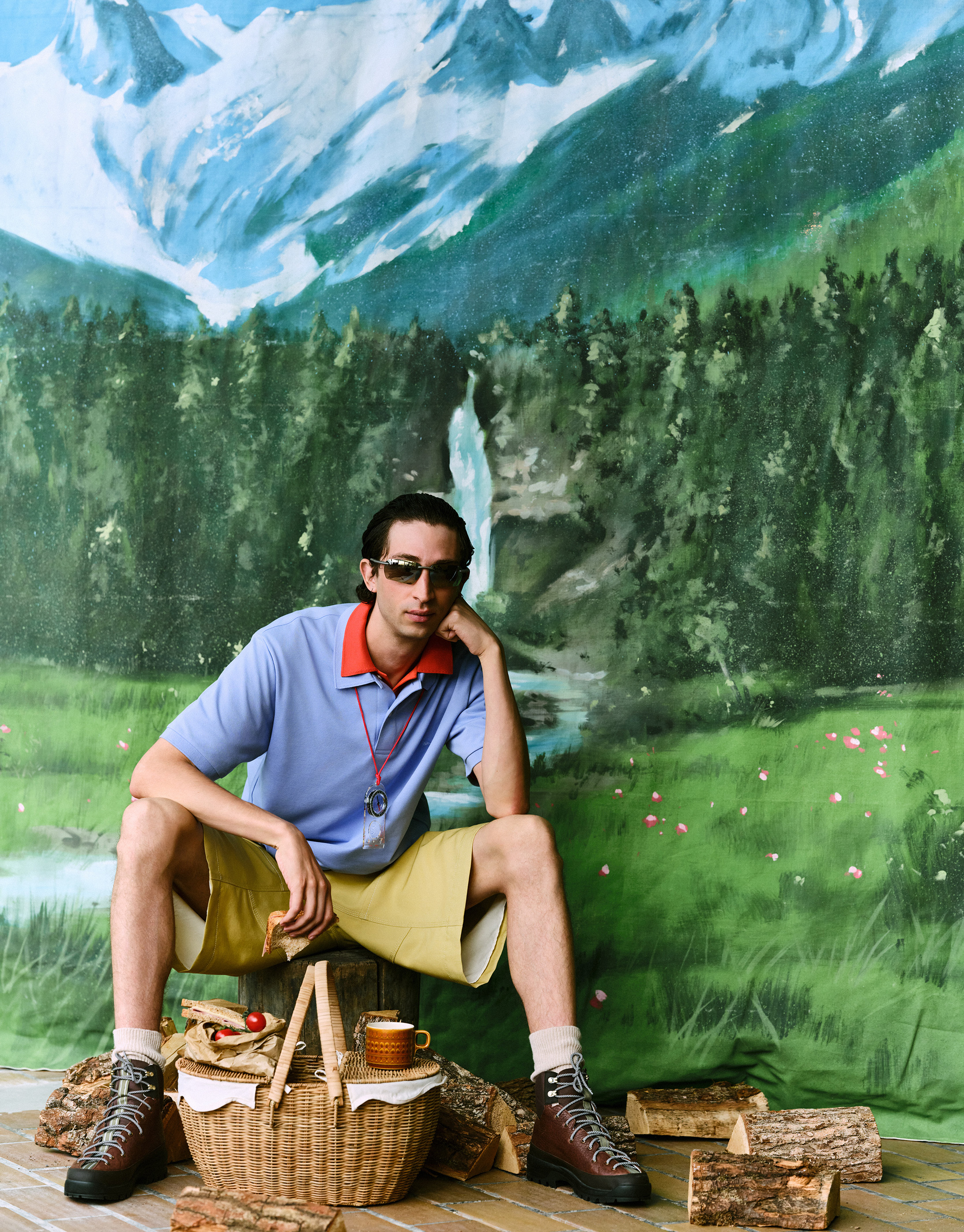 Polo shirts, both by JW Anderson X Uniqlo; shorts by Ami; boots by Grenson; picnic basket by Marks and Spencer