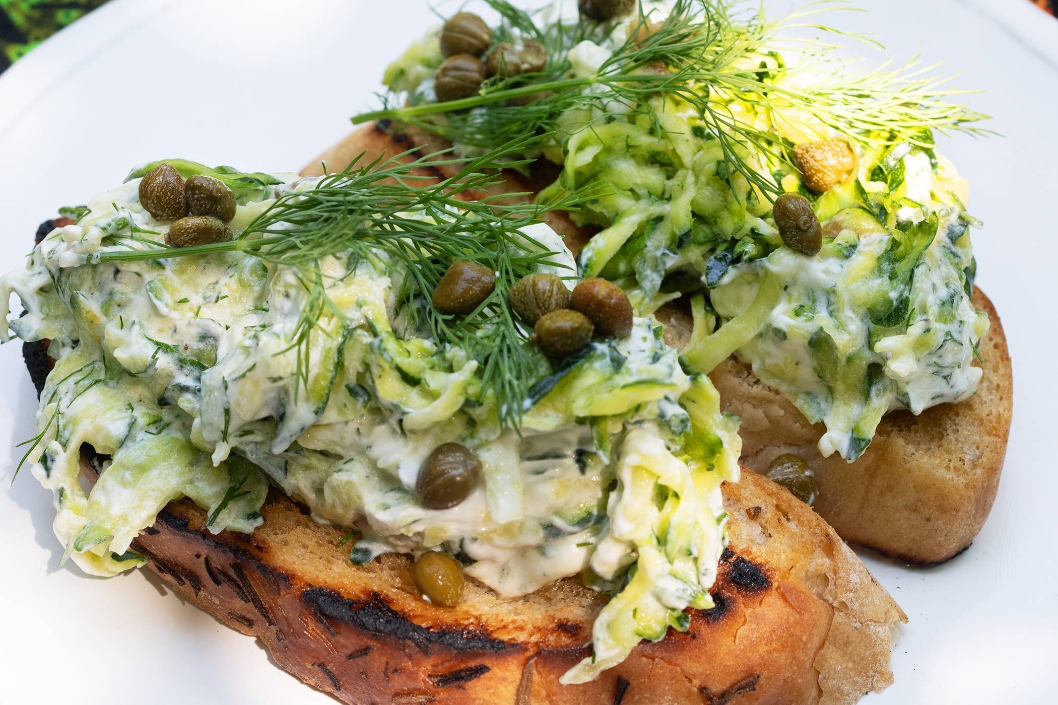 Courgettes with spring onions and dill on toast