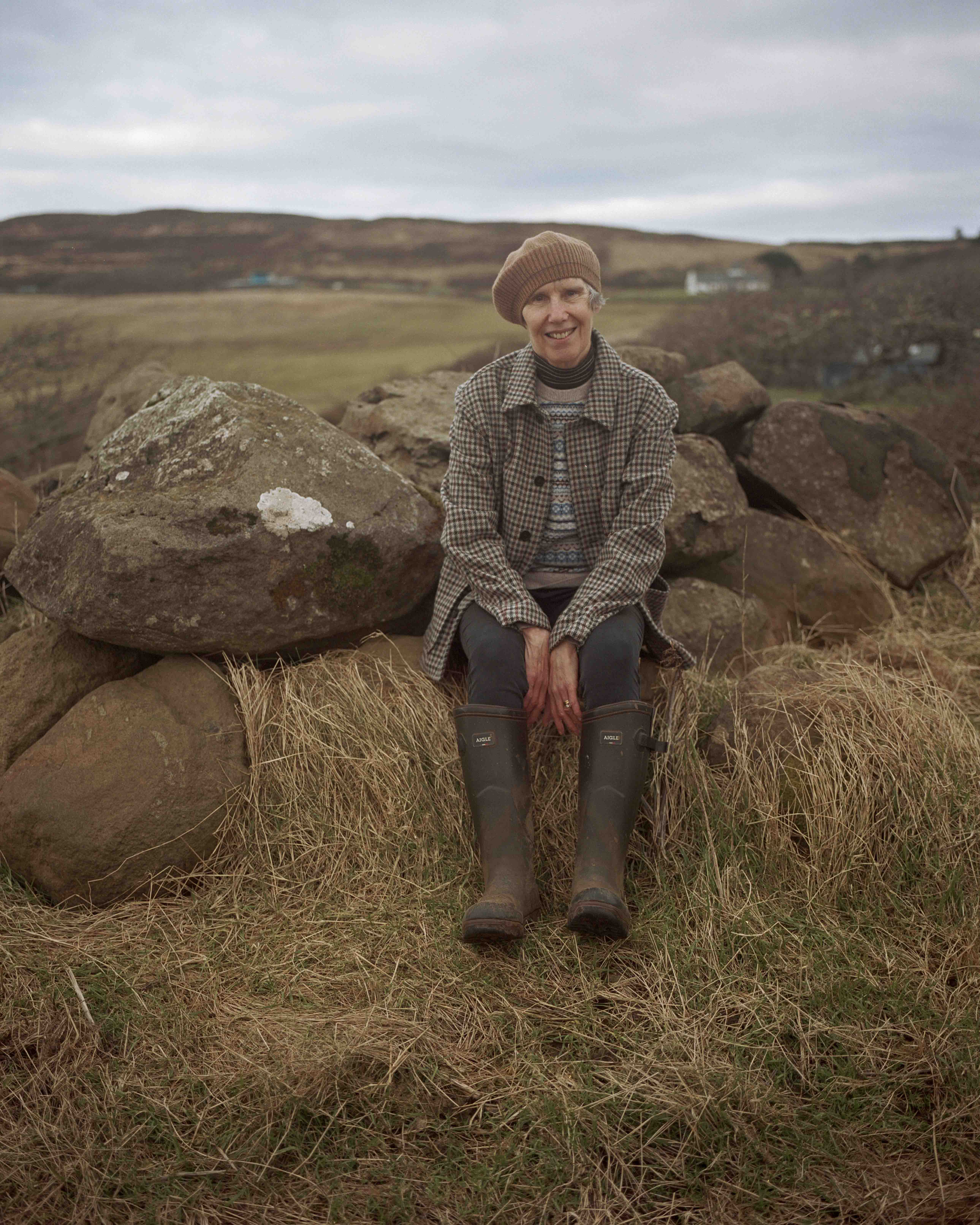 Lucy Montgomery, 70, writer: Lucy lives and works at Waternish Farm on the Isle of Skye with her husband Robert. She wears a weaver’s jacket by Johnstons of Elgin; and cashmere Fair Isle jumper and beret, both by Brora