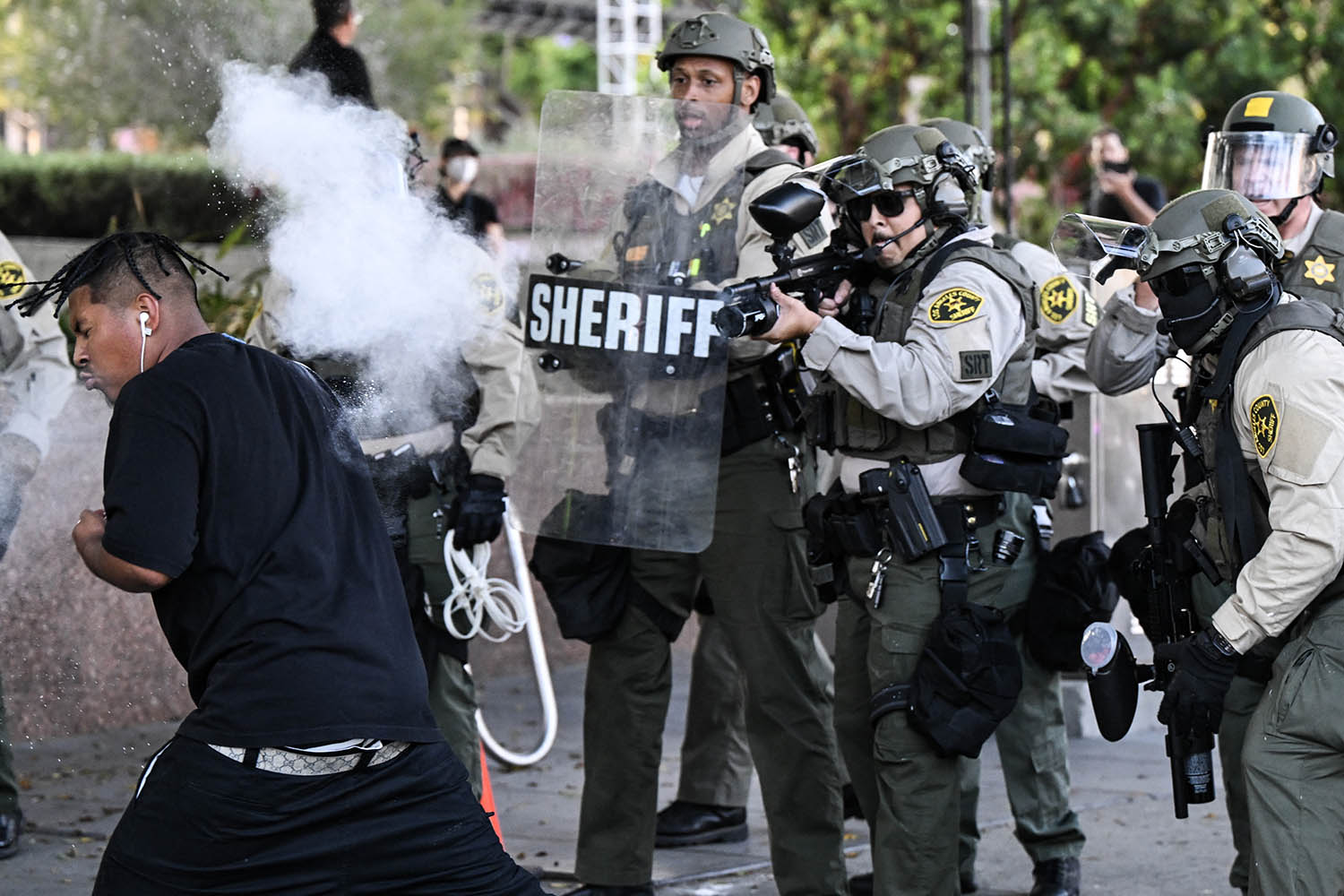 Sheriff’s department deputies fire a nonlethal round at a protester last Wednesday