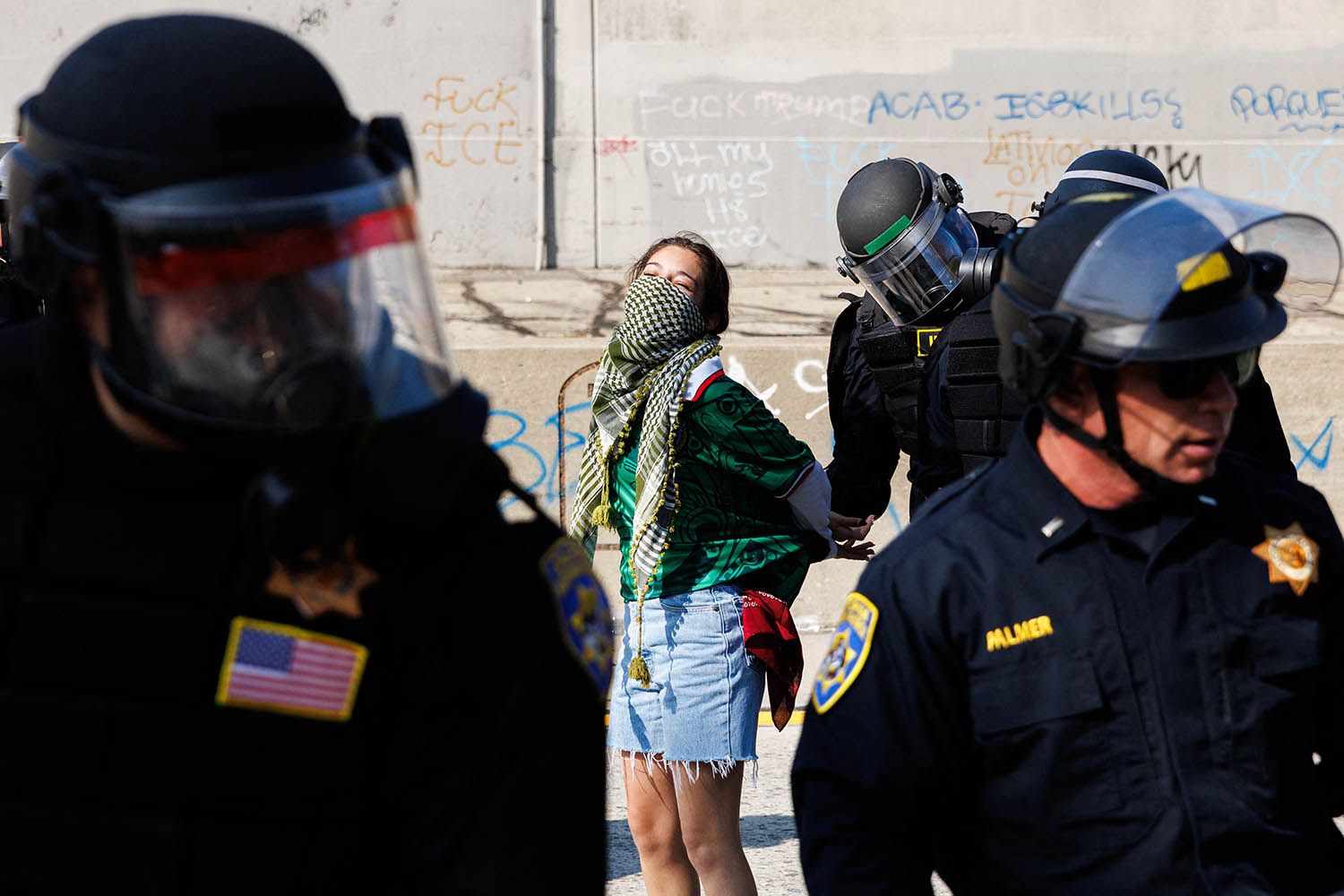 A protester is arrested by highway patrol officers last Sunday