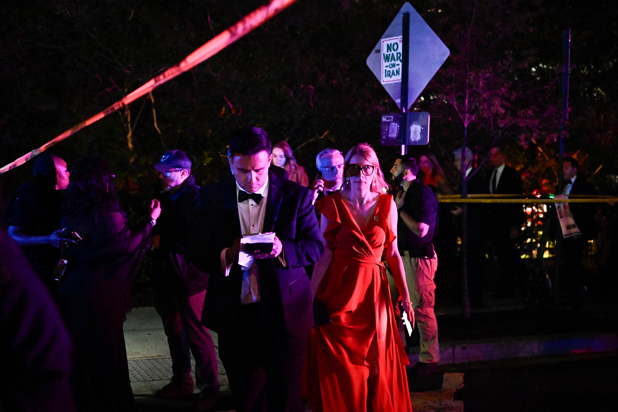 Attendees leave the Washington Hilton after shots were heard