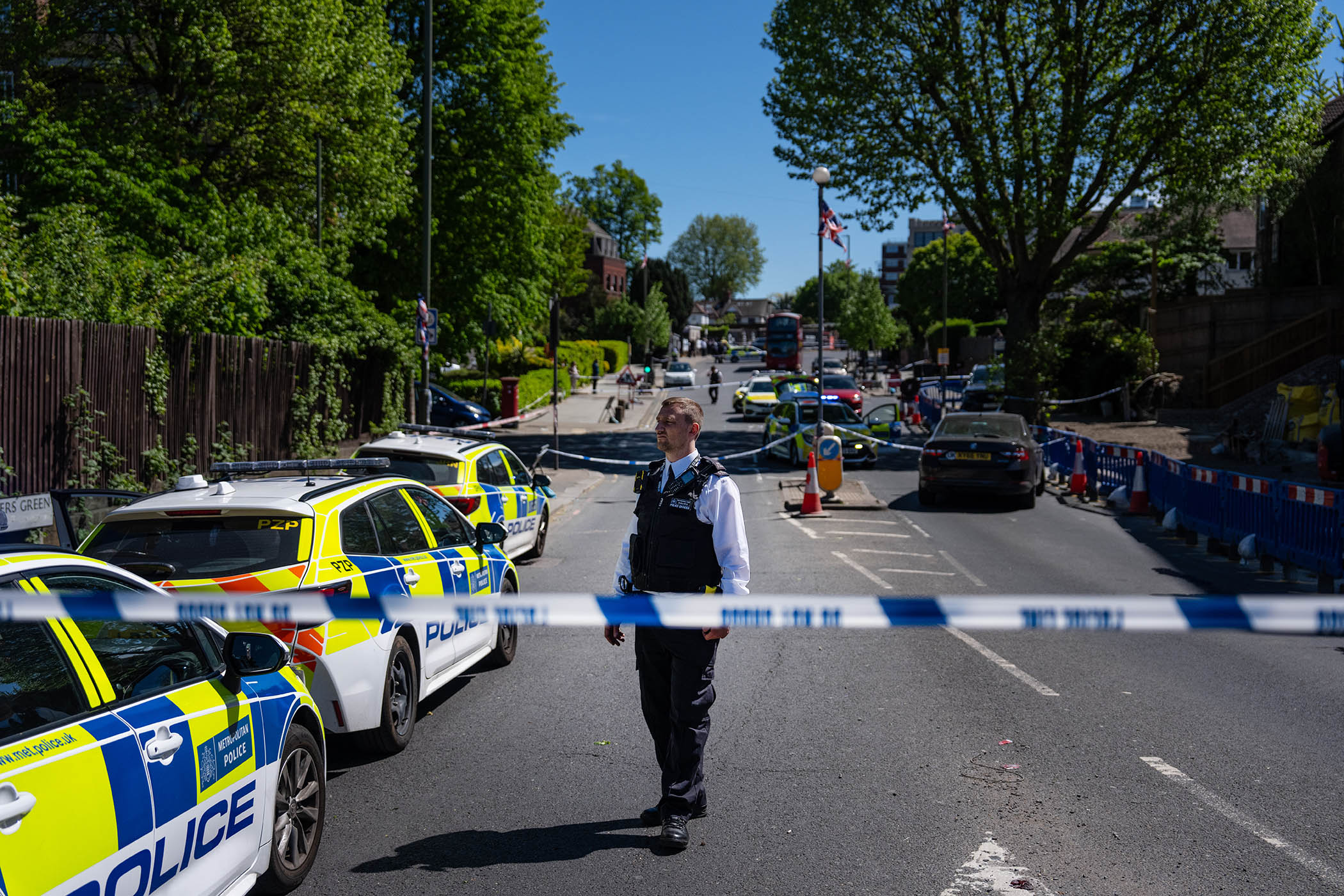 Police at the scene where two people were stabbed in the Golders Green area of London