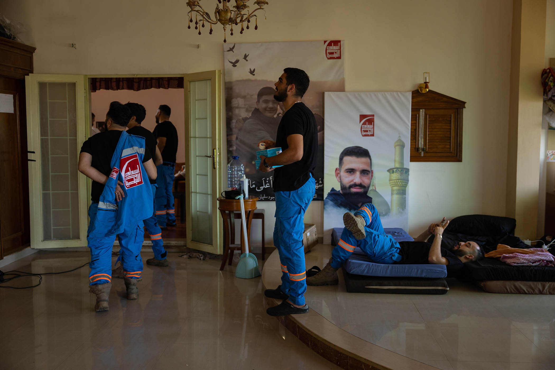 Members of the Nabatieh Ambulance Service gather in front of posters of their colleagues killed by Israeli strikes.